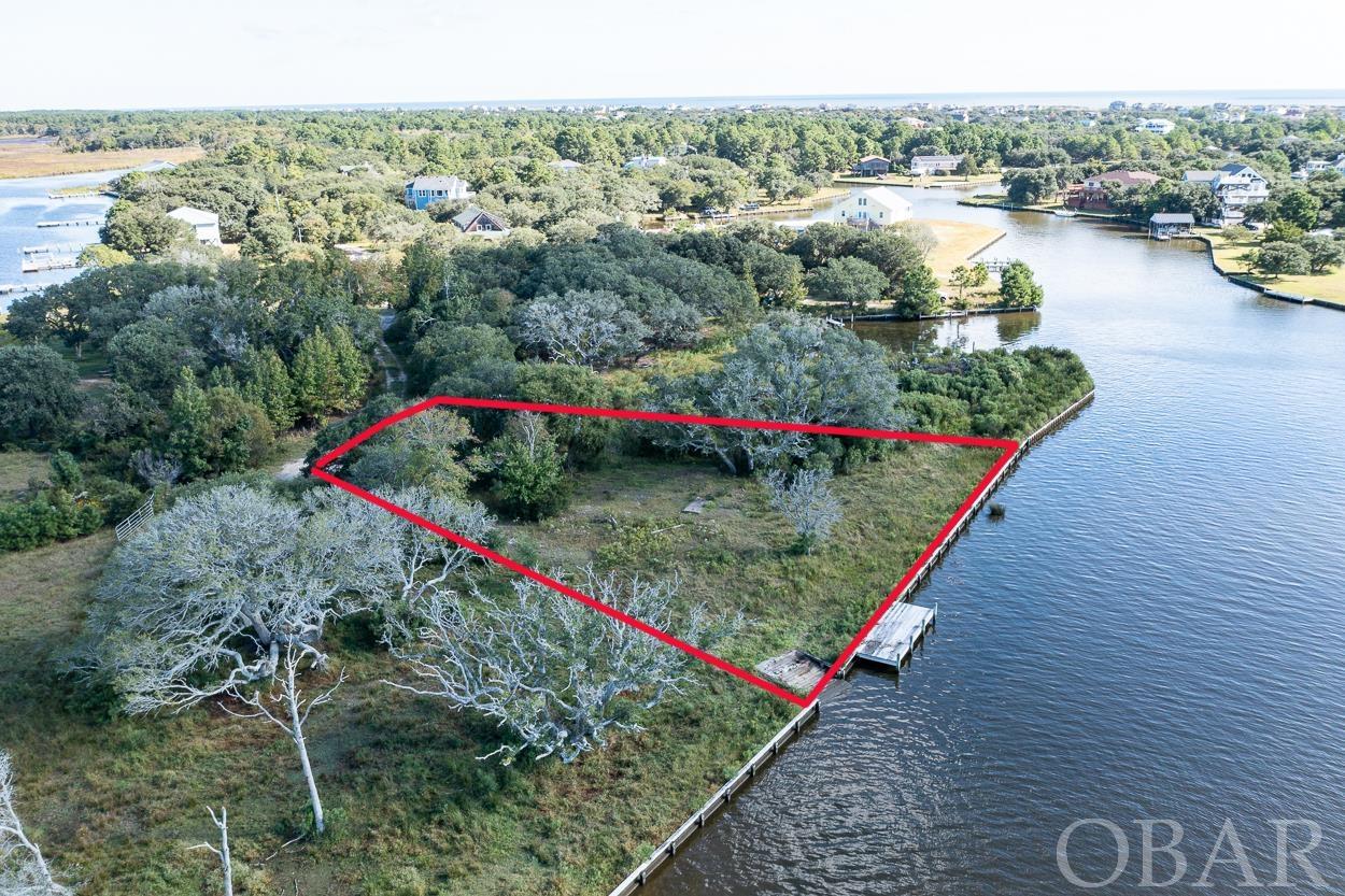 Build Your Luxury Waterfront Dream Home in Corolla on the 4x4. A rare fully bulkheaded, dock with boat ramp property on the water -- Own 1 lot (2153 Mobjack) or all three lots 2150 Mobjack (MLS116276) & 2151 Mobjack (MLS116277) and create your own private oasis. You will not find a more iconic LOCATION! This canalfront, bulk headed lot will provide incredible views of the Currituck Sound and Lighthouse. Add in a quiet cul-de-sac and the natural beauty of the Spanish Mustangs roaming about, and you have paradise.
