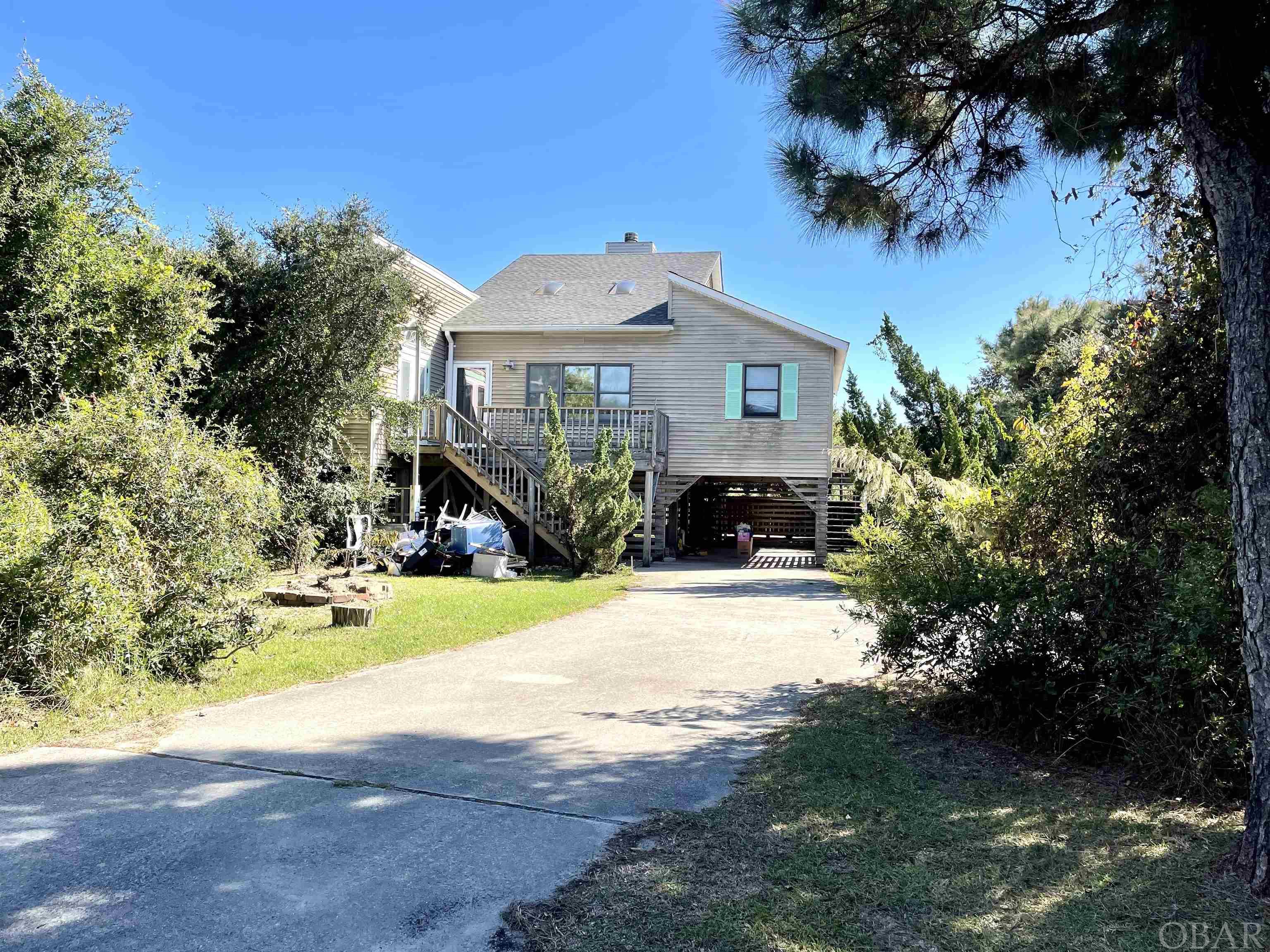 This is the one that you have been waiting for! What a perfect location for this wonderful beach home in Southern Shores. Just a short walk away from the Ninth Ave. beach access and just a little over a mile from the village of Duck with all the wonderful restaurants and shopping.  Previously used as a primary residence but with a little updating, this could be your perfect second home getaway or with the private pool in the back yard it could also function well as a rental investment property. The large 18,000 sq. ft. lot backs up to common area for added privacy to the south.