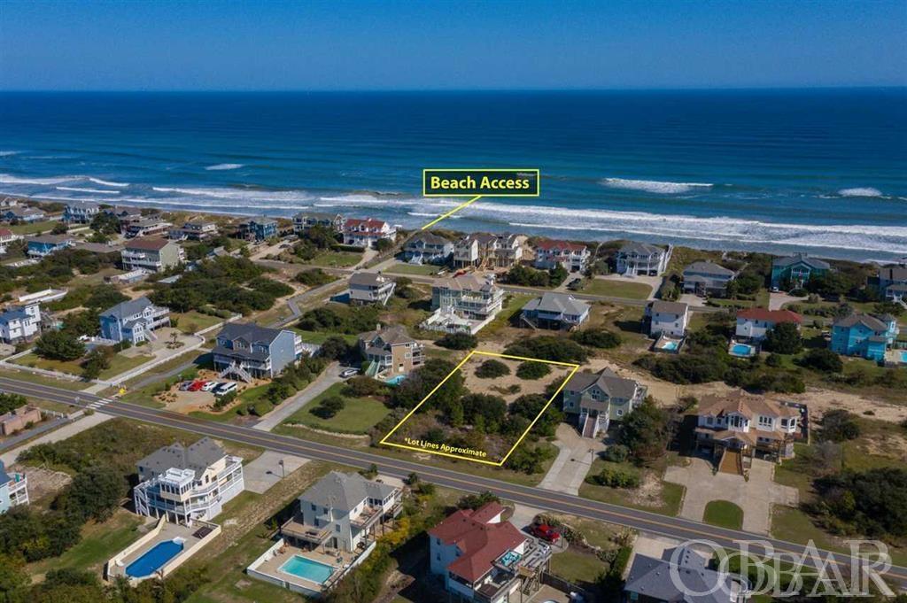 Beautiful, high & dry Whalehead homesite, just 2 lots from the Ocean, with close beach access just 2 lots away, ready for new construction of your custom Beach Home.  This naturally semi-cleared homesite offers a naturally elevated building pad location, is in the favorable X-Flood zone, and provides the preferred rear loaded design, providing Ocean Views from the rear windows and decking of a future home.  Beach Access is just 2 lots North at Mackerel Street, taking you to the wide and gradual sloping Whalehead Beaches.  Close proximity to conveniences at Monteray Plaza, Timbuck II shopping area, Corolla Lighthouse, and the Whalehead Club in Historic Corolla.  No HOA fees to be concerned with in this community. Recent survey available to buyer at no cost, health department site evaluation on file, attractive custom house plans, and 7br septic permit have been completed for this site. Available in associated documents.  This particular design features 7 bedrooms, 8 baths, rec room, theater room, elevator, pool house / tiki bar, large pool, and of course a buyer can build whatever they wish.  Construction services and consultations available, call to discuss.  Take advantage of the improved lower maintenance building materials to custom build a high quality new home just to your liking, and to modern designs and styles!  New home ownership provides greater 'ease of ownership', and renters love and will pay a premium for new homes for their vacations, improving rental income.