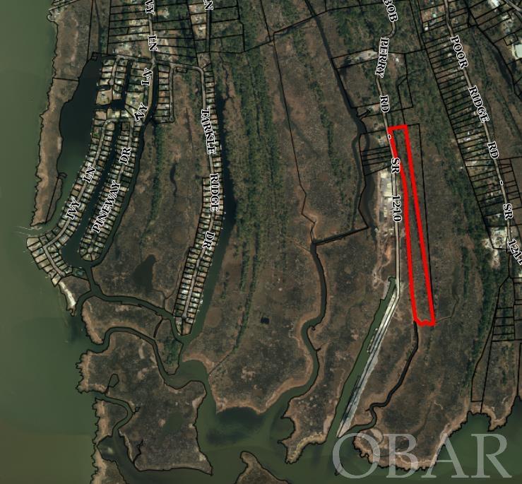 Imagine almost 2000 feet of canal frontage on 15 acres with access to Kitty Hawk Bay – only minutes from the beach! Design and build your special Outer Banks hideaway surrounded by natural habitat. Buyer would need to construct a bridge from Bob Perry Road across the canal to access the property. North end of property was recently surveyed to determine location of potential bridge.  Health Department has approved a 3 bedroom engineered system. Buyer also has the option of building an Accessory Dwelling Unit on the property (see attached docs for details).
