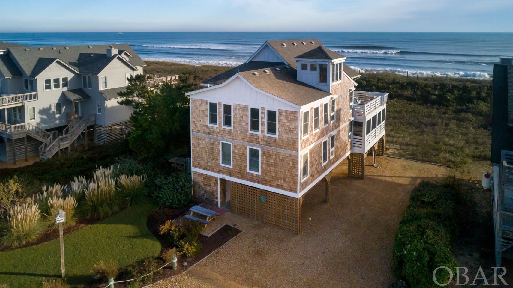 Gorgeous oceanfront home in Sanderling with a walkway to the beach right at your front door! Used only lovingly as a second home, the home is in impeccable shape and boasts new cedar shake siding, all new decking and railings, a new HVAC, and new exterior trim paint in 2021. With 5 master bedrooms, two living areas, a well equipped kitchen, a large den with pool table, gas fireplace and wet bar, a ships watch, and multiple screened in porches and decks overlooking the Atlantic Ocean, this home is truly one of a kind. Also enjoy covered parking under the home with a ChargePoint Home Flex Electric Vehicle Charger plus a one car garage, and plenty of storage. Roof was replaced approx 10 years ago. Projected to do over $141K in Rental Income!
