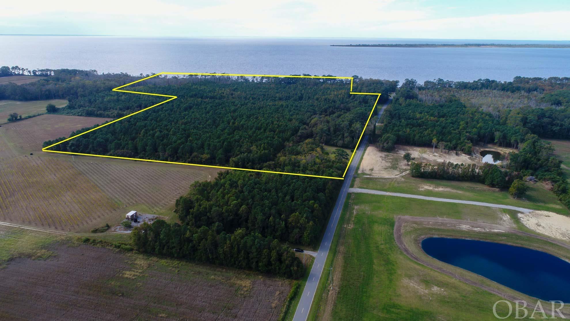 SOUNDFRONT ACREAGE. The family has decided to sell. This unique tract is now available. 57 acres of rolling woodlands on the Albemarle Sound. 1400 feet of sound frontage and 400 feet of frontage on Fisher Landing Road. Enjoy multiple nearby golf courses, fishing, hunting, or a special wine grown on adjoining vineyards. With easy access to the Outer Banks Beaches plus Hampton Roads and Elizabeth City. Ideally suited for development or the discerning buyer looking to create a family compound with a few secluded homes scattered over the wooded acreage. Contact agents for more details and information.