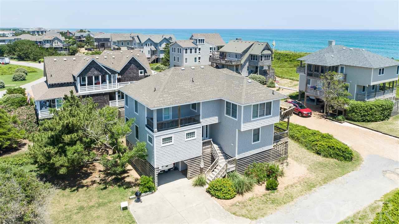 A RARE FIND - 5 BEDROOM SEMI-OCEANFRONT (2ND TIER OCEANFRONT) IN SANDERLING!! NO STREETS TO CROSS TO GET TO THE BEACH!  Enjoy stunning ocean views and direct beach access from this lovely home!  This Olin Finch built home has been meticulously maintained by its original owner!  Beautifully furnished with an open and spacious great room/kitchen as well as a lovely sunroom...perfect for family gatherings and entertaining!  Expansive sun decks and covered decks to enjoy the amazing ocean views!! Recent improvements include:  *Water Heater *HVAC system upstairs *Hardwood Floors upstairs in living room, hall way, and Queen bedroom *Carpet on both sets of stairs and in two downstairs bedrooms plus new painting in those rooms ( twin room and bunk room) *Commercial ice maker under bar upstairs *Updated fixtures over upstairs bar area *Refrigerator on lower level.  Much of the top floor decking and benches have recently been replaced.    Discover Sanderling...a special Duck subdivision, boasting a mile of oceanfront and of soundfront. The uncrowded beach is unique to Sanderling. Amenities include nature paths throughout, a soundfront pool, tennis courtsand a well furnished Health Club exclusively for owners, their families and accompanied guests. The Sanderling Inn and 3 highly acclaimed restaurants are within a comfortable walk.  BEACH LIVING AT ITS FINEST...A MUST SEE!