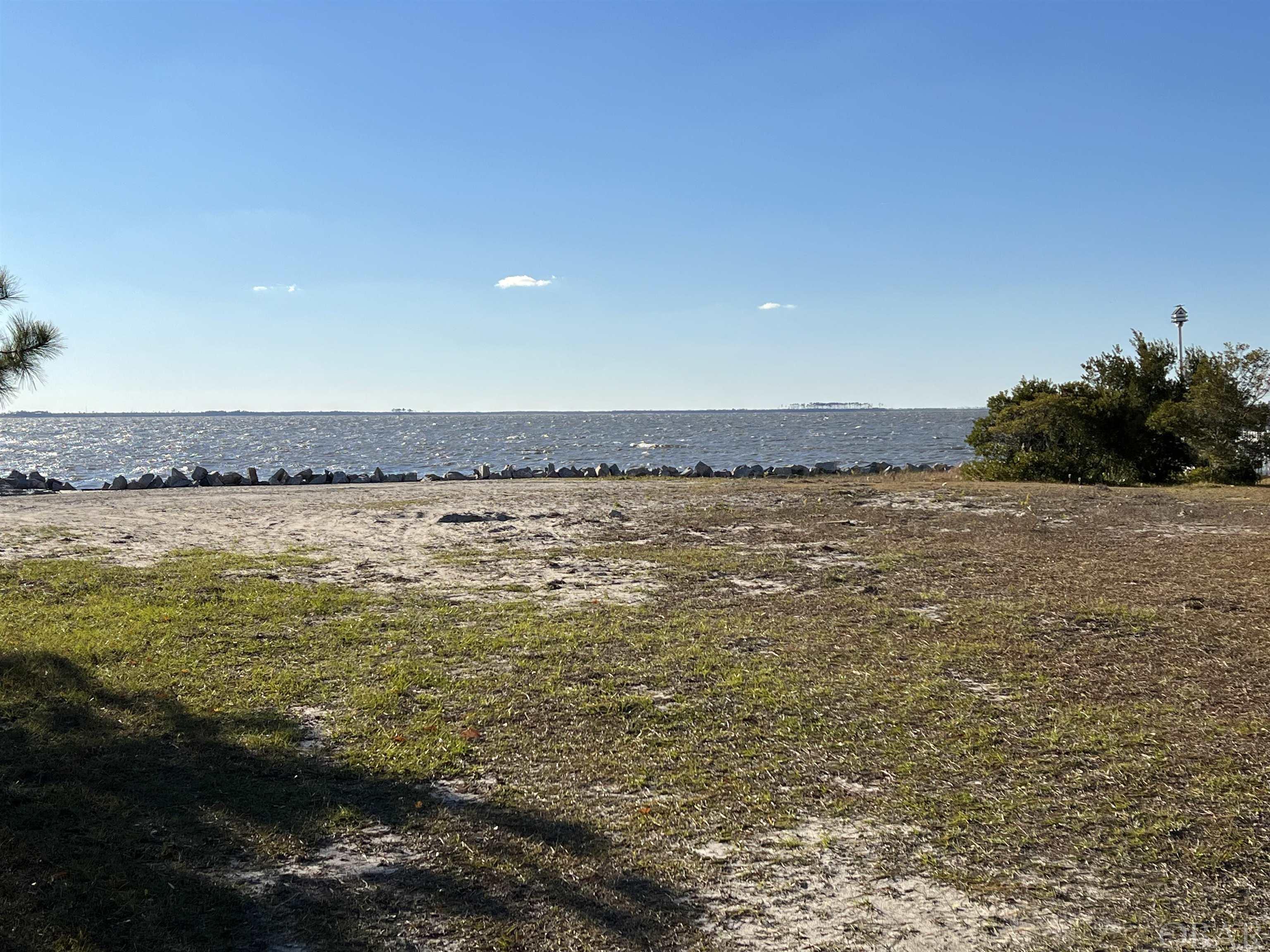 SOUNDFRONT homestead site with panoramic views of the Croatan and Albemarle Sound in exclusive boating community of Heritage Point! Amenities include a boat slip for easy access to the sound, a private sandy beach for your family to enjoy as well as a sound front pier. Watch evening sunsets at the large neighborhood gazebo or right in your backyard. The seller has just completed work on the bulkhead. There is also a boat ramp and a boat house with some exercise equipment. This is the PERFECT homesite and last sound front lot in Heritage Point for your DREAM location on Roanoke Island close to the town of Manteo, Lost Colony, Elizabethan Gardens, North Carolina Aquarium, and Festival Park! All this and OUTER BANKS BEACH is a short drive away!