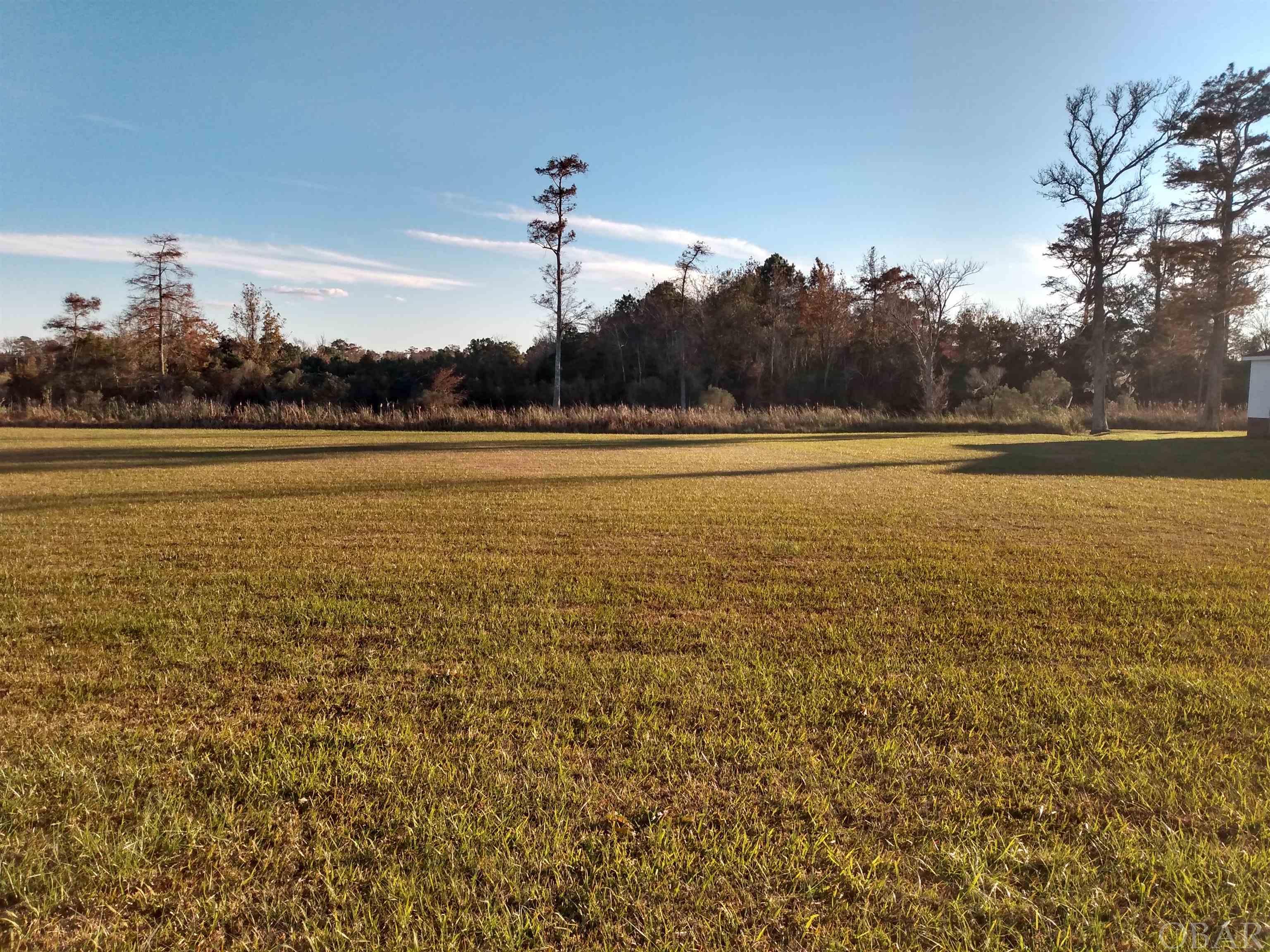 This canal lot provides spectacular views of the Albemarle Sound and gorgeous sunsets from the waterfront commons area! The rear of the lot is fronted by a canal navigable to the Albemarle Sound. The HOA and covenants have expired. An adjacent canal lot is also for sale. Underground utilities and permit for septic system available. Located just 5 miles north of Columbia, N.C. and within an hour of Nags Head, N.C. Priced to sell at only $27,500!
