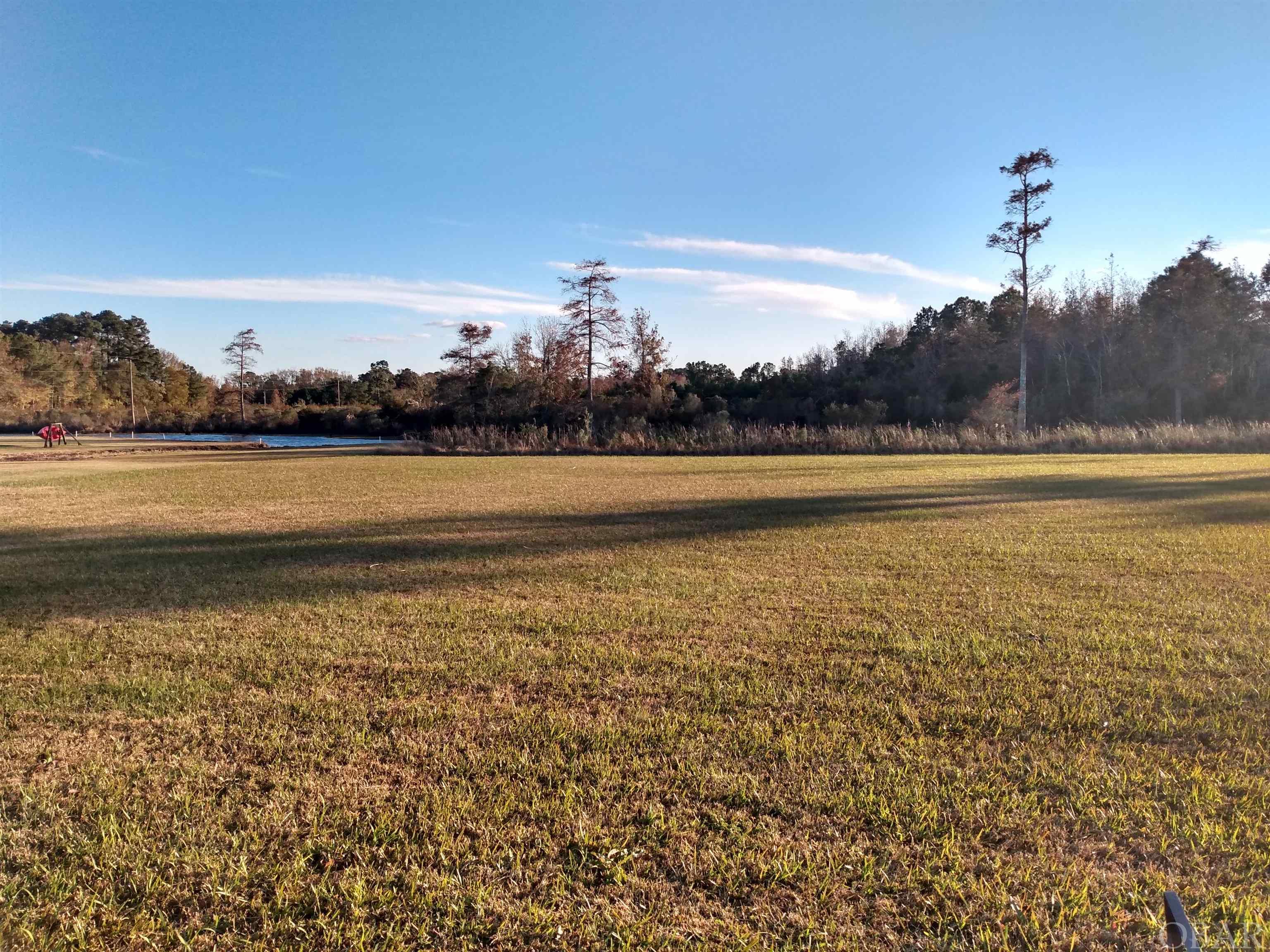 This canal lot provides spectacular views of the Albemarle Sound and gorgeous sunsets from the waterfront commons area! The rear of the lot is fronted by a canal navigable to the Albemarle Sound. The HOA and covenants have expired.  An adjacent canal lot is also for sale. Underground utilities and permit for septic system available. Located just 5 miles north of Columbia, N.C. and within an hour of Nags Head, N. C.! Priced to sell at only $27,500!
