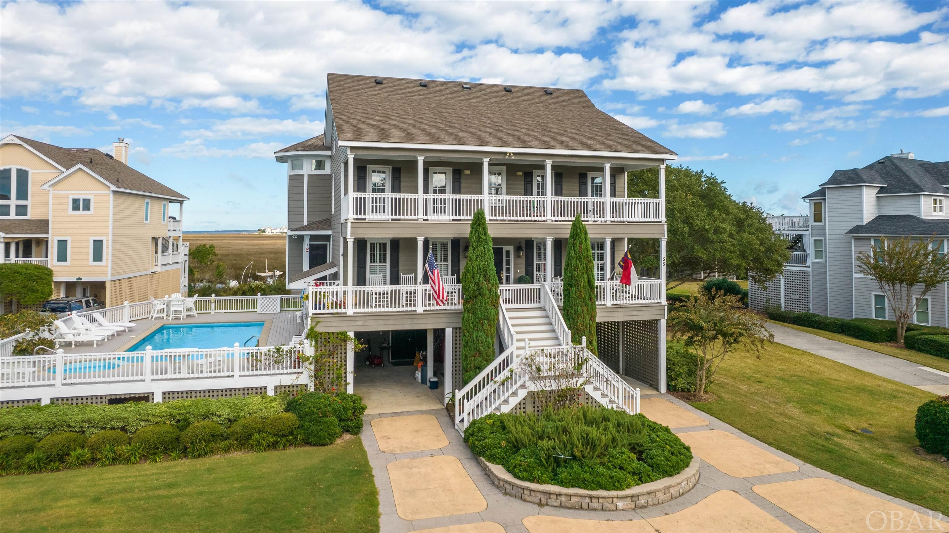 Rare opportunity to own coastal chic 5 BR home with both private & association pools! Southern Living style home, amazing water views abound, in highly sought after gated community of Pirate's Cove on Historic Roanoke Island. Main level has lovely guest room, office, living, kitchen, dedicated dining space with amazing views of sound & saltmarsh. Upstairs has two other bedrooms with shared full bath in hall, stunning primary bedroom offers fabulous walk-in closet & en suite with jacuzzi tub! Top floor has two beds, two storage closet/attic spaces, and "bonus" full bath for your guests to enjoy their own private getaway. The views are absolutely breathtaking!! Fisherman/handyman special downstairs with additional 900 sq ft of storage space, including "bonus" half bath, extra owners closet area & outdoor shower.   Relax in shade of porch, lounge in sun by your own saltwater pool, or hit the water in ease with 55 ft of boat moorage available right at your back door! 50 amp shore power also on dock directly behind house, for qualifying buyers per PCHOA bylaws.  Charming nautical community boasts world class Marina, ship store, community pool, clubhouse, owners pool, tennis courts, playground, & beautiful walking along docks. Pirates Cove offers mix of year round residences, second homes, & vacation rentals, and is host to the world famous Pirate's Cove Big Game Fishing Tournament!        Home being sold unfurnished, some furnishings may be negotiable. Please refer to PCHOA Bylaws in assoc docs for more info on association amenities & expenditures. Boat slip available to qualifying buyers with boat, $160/yr fee. $300 Buyer Conveyance Fee due at closing to PCHOA. Listing Agent is related to Sellers.