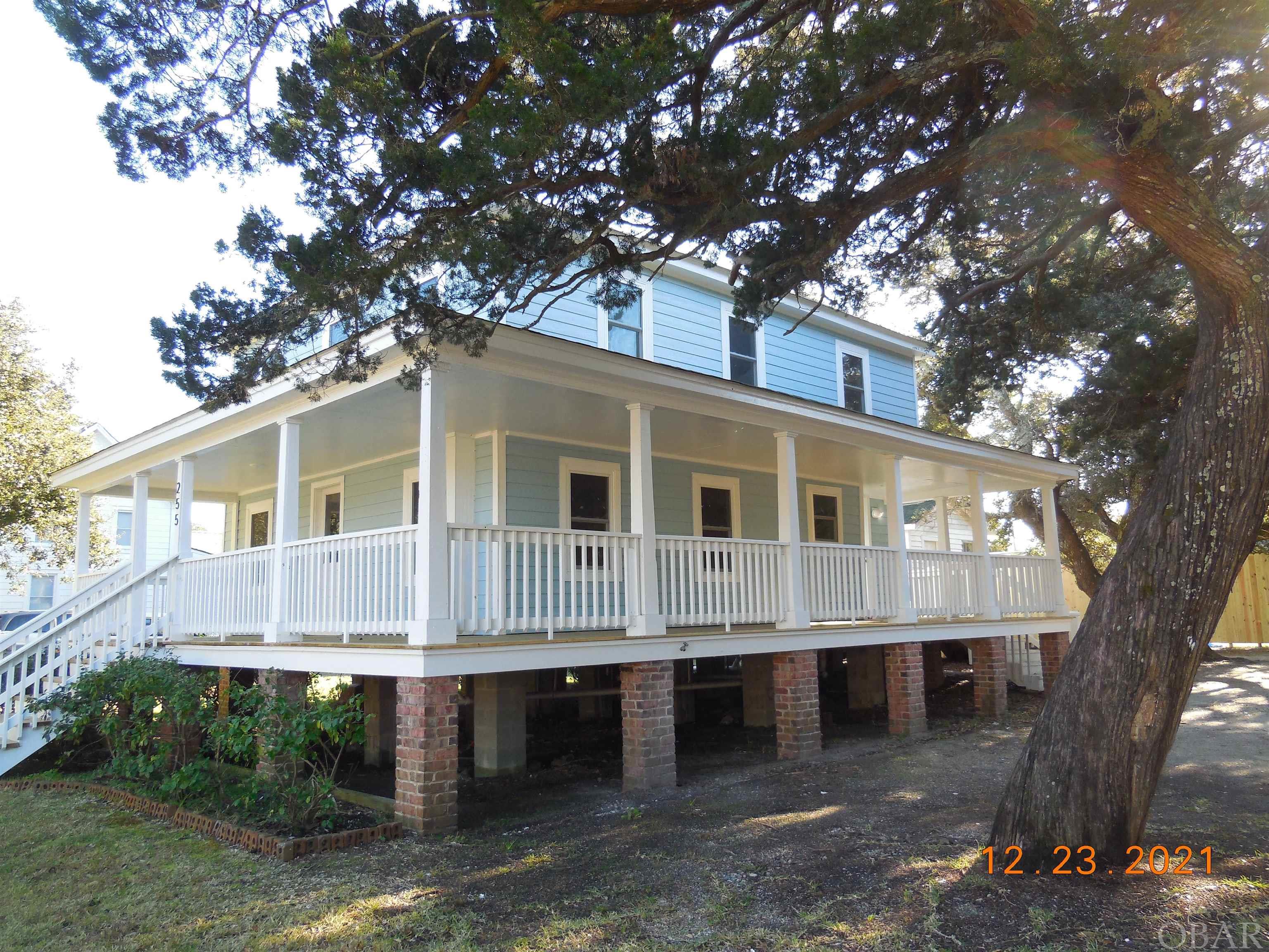 This charming historic 4 bedroom, 3 bath island home located near the Ocracoke Lighthouse is waiting for you to call home! The property has beautiful old gnarled live oaks. Also, there is an unique out building that would be perfect for an artist's studio. New in 2021: exterior LP smart siding and PVC window trim and corner boards, windows, interior and exterior painting, porch ceiling & deck boards & front steps. The "L" shape front/side covered porch is a great place for rocking chairs or porch swing to enjoy evenings or people watch. Wood floors, tiled bath/showers, beautiful original interior steps and banister, original interior doors, mini splits to heat/cool the downstairs and heat pump to heat/cool the upstairs. Open kitchen/dining, utility area, living room, bedroom and full bath on the first floor. 3 bedrooms and 2 bathrooms on the second floor.