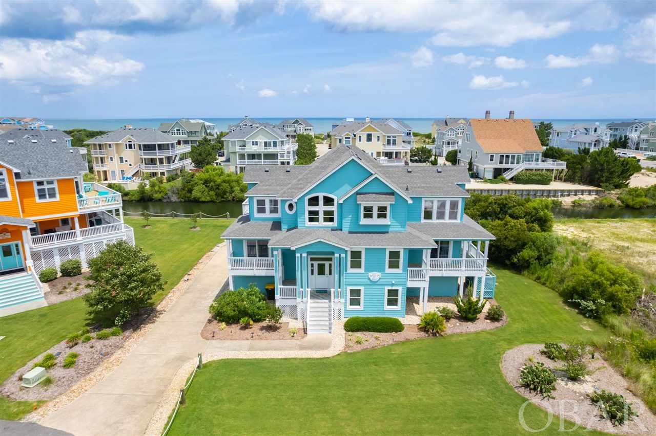 795 Mercury Road; this is a rare 7 bedroom opportunity within Corolla's most prestigious community, Buck Island. Offering 7 bedrooms, 7 baths, with large private pool & spa, recreation / pool table room, Ocean Views, ample decking, all just steps away from the beautiful beach, this home offers everything guests and owners desire.  Buck Island is the premier Outer Banks neighborhood, a private enclave with gated entrance, curbed / tree lined / side-walked streets, quality & attractive surrounding properties, large community pool, tennis courts, playground, bathhouse and beach access, and wide beautiful beach.  In this third row back location, "The Aegean C" offers ocean views, is just a short walk to the beach, via sidewalks to the community pool & amenities, and to TimBuck II & Monteray Plaza for shopping and dining... park your car for the week! Also Buck Island is one of the only golf cart friendly communities around.  This custom designed home offers a bright open great room, is rear loaded focusing on the ocean, it's private pool, the pond front setting, and provides comfortable spaces for all inside and out, with ample open and shaded decking. Beautifully landscaped, with sodded & irrigated grounds, lush flower and plant beds, and landscaping rock under and around home perimeter.  Above average sized pool and pool area.  No / low traffic cul-de-sac and it's own private driveway with ample parking (as opposed to shared driveways). This is a quality built home, with granite kitchen counters and stone backsplash, Luxury Vinyl Tile & tile floors, custom trim package, fresh exterior paint, gutter installations, etc.  Well cared for and maintained by attentive owners, and ready for a new family to enjoy. Offered fully furnished, including plenty of outdoor furniture, including high quality polywood furniture pieces.  This Buck Island home provides a great East Coast coastal opportunity, in a top flight private community, schedule your personal or virtual showing today!  Rental Projection in Associated Documents.  With all the features vacationers desire, this is a very popular rental property.  Rental income reflects the owners personal use of the home during the season as well as off season blocks, so availability of the property and rental income could be increased.  Additionally, rental rates were kept low, but have been increased for 2022. Rental reports and rental projections available in associated documents.  Consider this property and neighborhood for your Outer Banks home, and act quickly to capture the summer rental income and/or enjoyment!