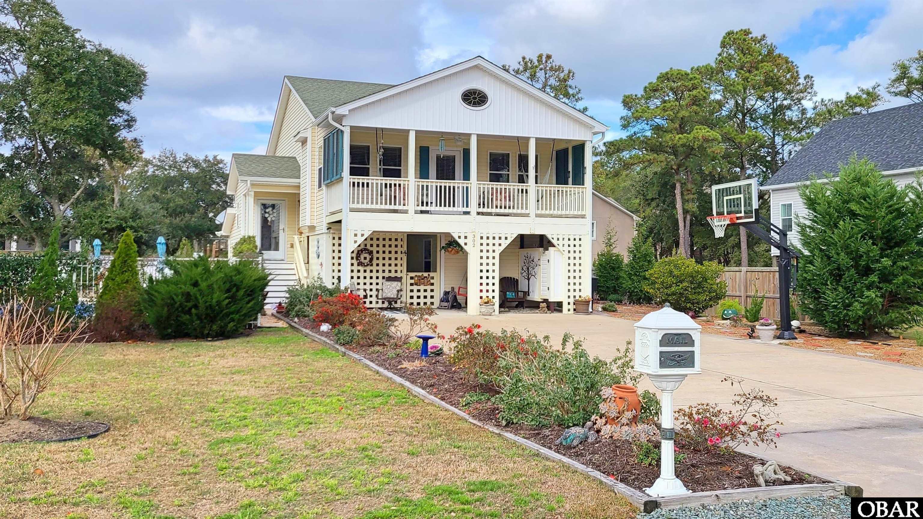 Better than new, and furnished, too!  This quality-built home has been substantially renovated and COULD NOT be replicated at this price.  Major kitchen renovations include gleaming quartz countertops and quality white cabinetry.  All baths have been handsomely upgraded as well.  Oversized lot WITH HEATED SALTWATER POOL includes many landscaping improvements to maximize enjoyment and create inviting recreation areas.  Since construction, the home has been used as a year-round residence with top of the line materials and furnishings (which convey.)  Last year the owner offered it for weekly rental for a short time, and spared no expense in creating an appealing retreat.  It offers ample linens, towels, games, pool toys, etc.  Most of these items convey through Bill of Sale with a short list of exclusions.  Central location in Kill Devil Hills is close to shopping, dining, nature trails, and beach.  Whimsical clouds painted above the hot tub with lattice screening denote the loving care this cottage has enjoyed.  Ask about the full list of improvements for this beautiful home.