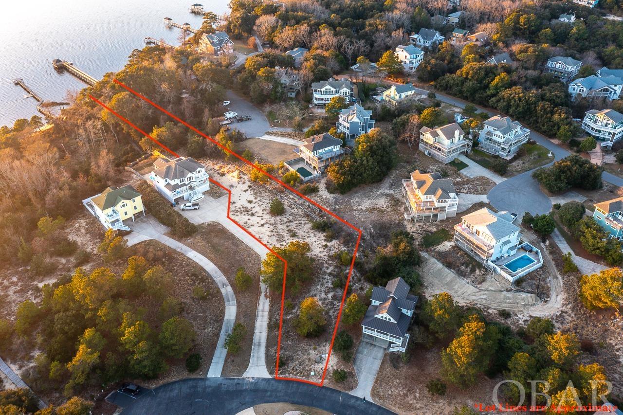 38,000sqft Soundfront lot perched in the western most cul-de-sac of Duck's coveted Bias Shores Subdivision at less than $10.40/sqft! The plat features a 7000sqft X-Zone homesite with sweeping views of the Currituck Sound. Just beyond the canopy of majestic live oaks, the sound and sand create a breathtaking private oasis for future residents. Rare opportunity to build a sprawling Soundfront estate less than a mile from Duck Village's famous restaurants, coffee shops, shopping and spas. The picturesque Bias Shores Community includes a private ocean access with parking, sound access with gated pier and gazebo, tennis courts, clubhouse, pool and picnic area. This lot offers future owners and their guests a luxurious soundfront lifestyle in the heart of Duck.