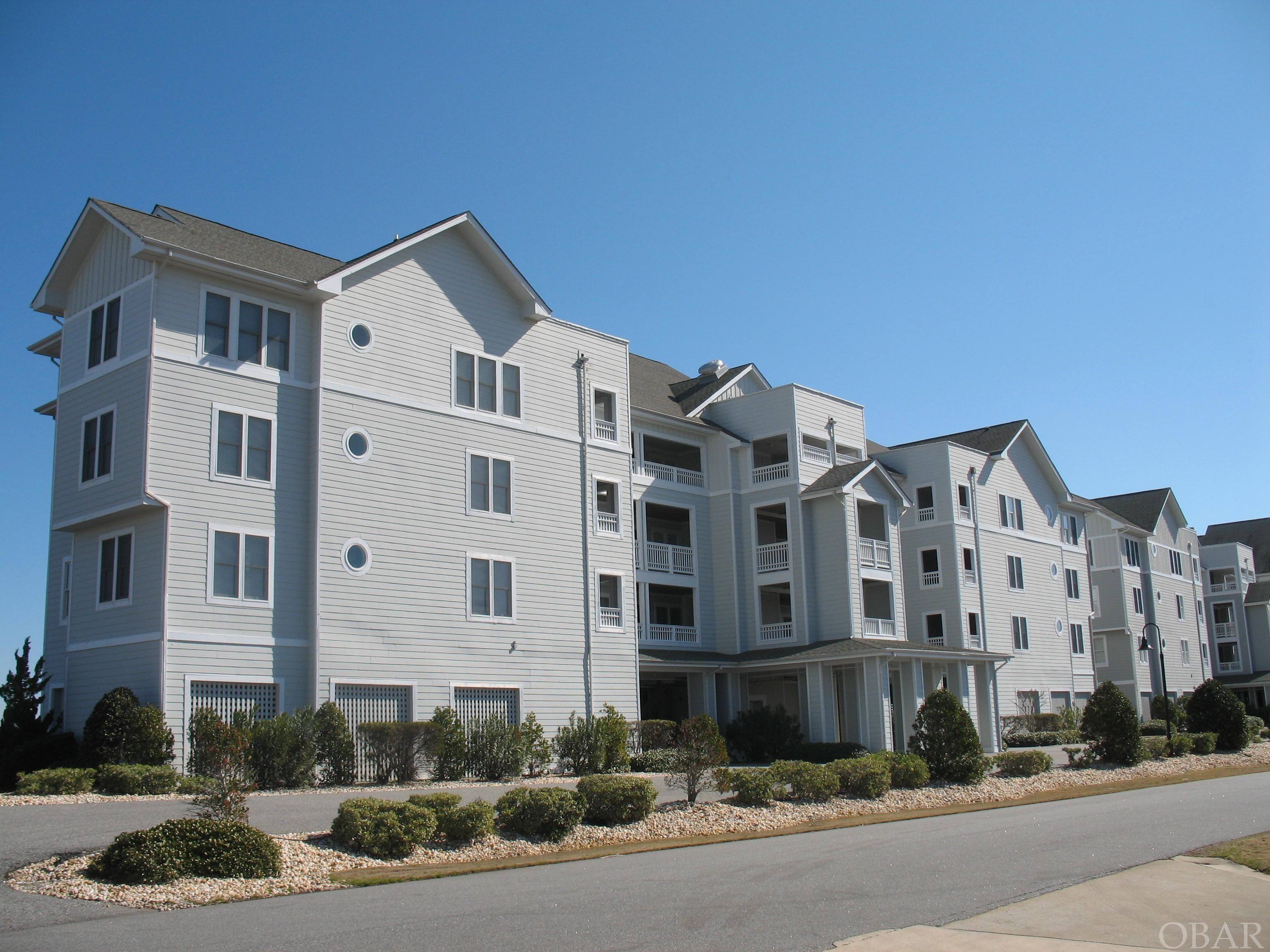Enjoy the best of the best on the Outer Banks!  1950 sq ft,  4 bedroom, 3 full,  bath with a rental projection of $49,644.00. Current owners have enjoyed as a second home.  The only Soundfront end unit in Ballast Point Villas, Pirates Cove.  This beautiful condominium features two master suites, two guest bedrooms and three full baths.  A wrap around deck to enjoy sunrises and twinkling lights of Nags Head at night.  ELEVATOR building.  Covered assigned parking and a ground level storage unit. Pirates Cove is a 24/7 gated, golf cart friendly community with a Clubhouse with pool and snack bar, owners pool, fitness center, tennis cts, playground and miles of lighted docks.  Adjacent restaurant, ships store, tiki bar and full service marina.  Only minutes to the nearest beach access or about 25 minutes to Oregon Inlet by boat.  Four bedroom soundfront condo's do not come available too often and this one is sure not last long.   Call the listing Agent to schedule your appointment or call for more details.
