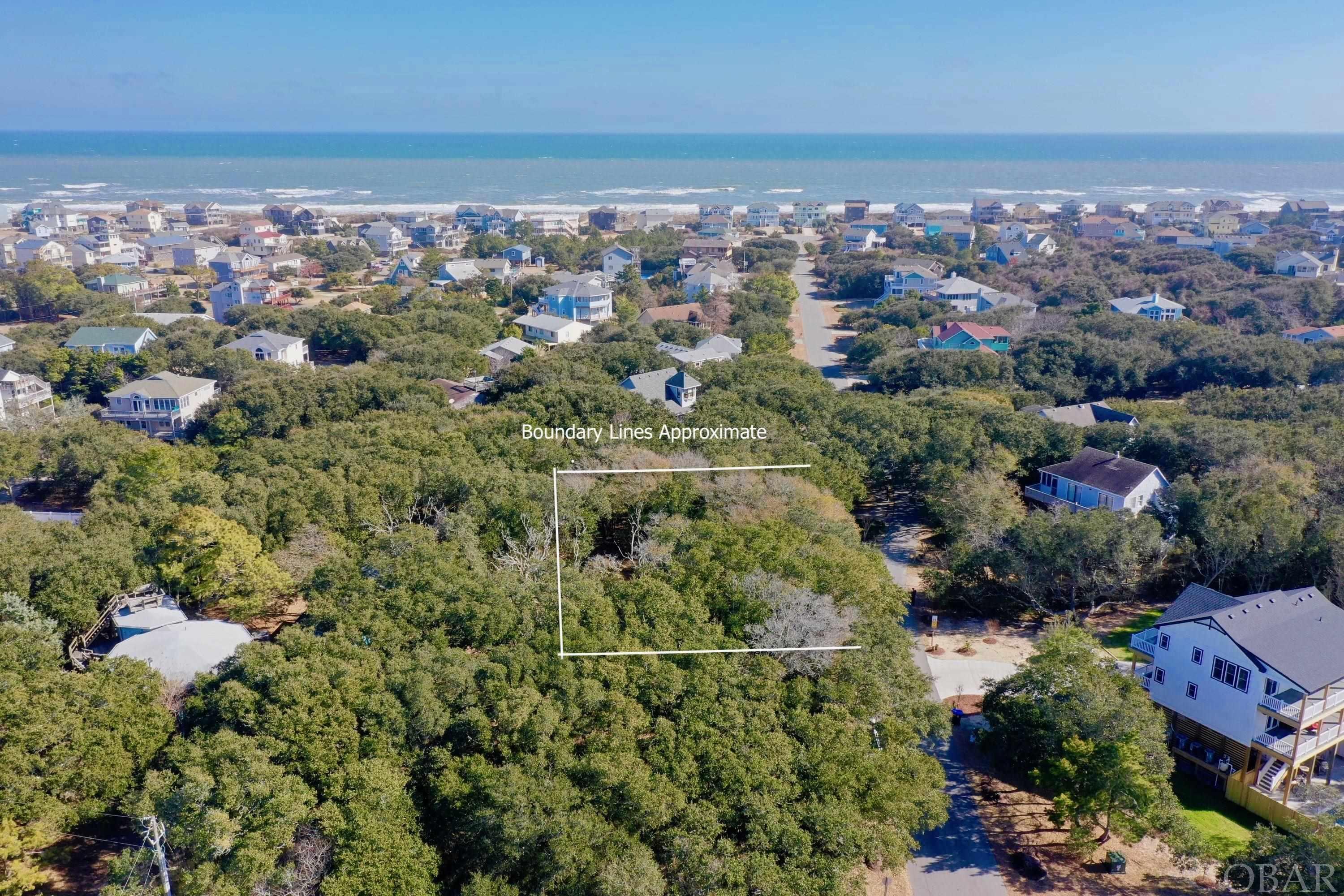 15,000 sq. ft. homesite sits in an X flood zone (no flood insurance required) with majestic live oaks in the private Caffey's Inlet Hamlet. Caffey's Inlet was the first neighborhood in Duck to create a Soundfront park for the entire neighborhood to enjoy water sports and breathtaking sunsets. This desirable ocean side location is the perfect place to build your dream home. There's a small community charm with a mix of second homes, primary homes, and some rentals. If you want to be on the quieter side of Duck, this is for you. The community ocean access is just a short walk away with it's less crowded beaches and plenty of elbow room to spread out. Caffey's Inlet Beach has one of the few Lifeguard stands in the town of Duck. The Village of Duck is just a short bike ride away (1 mile) where you can enjoy boutiques, award winning restaurants, coffee shops, yoga, soundfront  boardwalk and the town park. Duck is the most sought after of Oceanside Areas on the Outer Banks offering a sidewalk through the entire town– great for biking, walking, running.