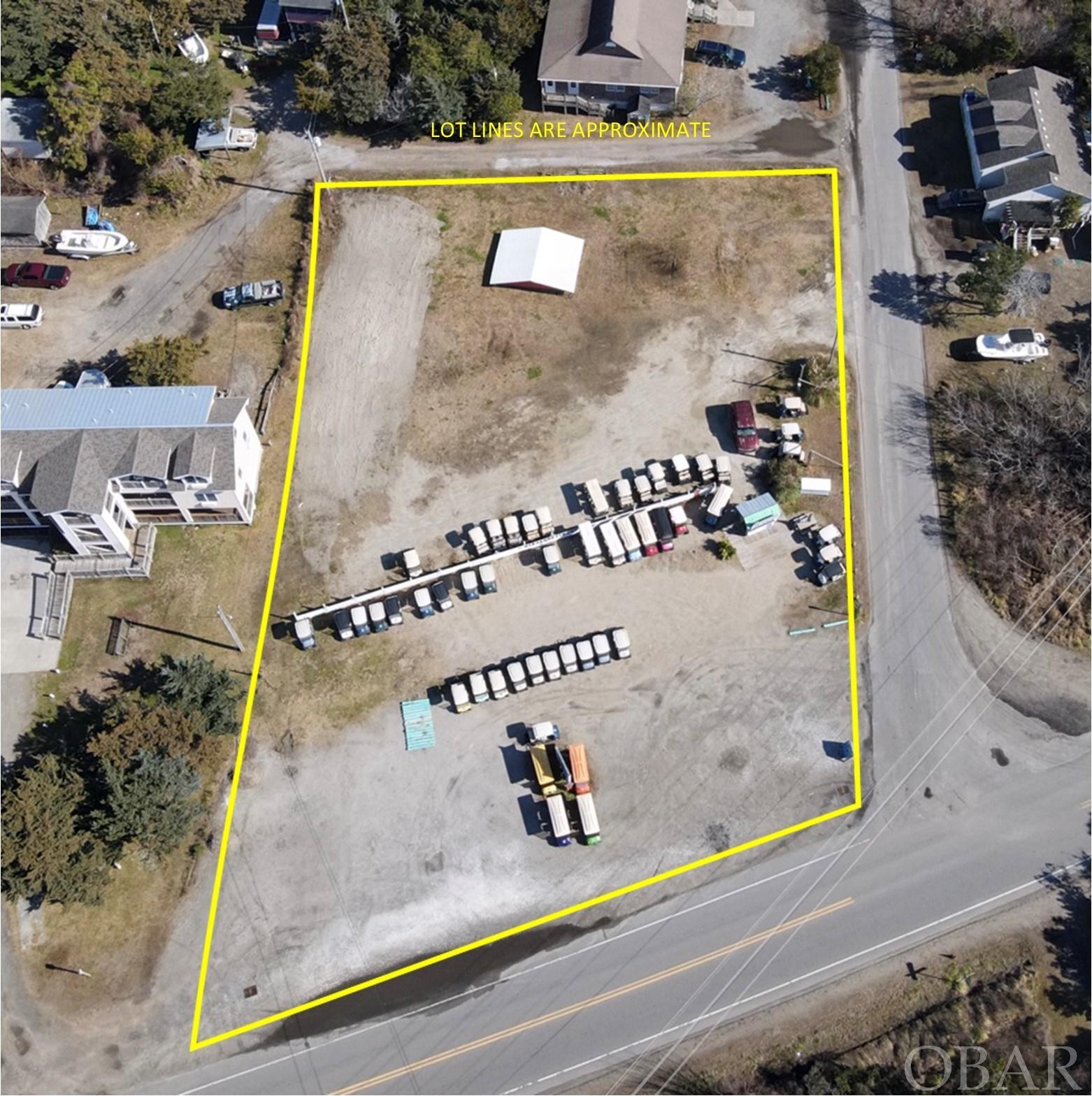Make your dream a reality on Ocracoke Island! Large corner commercial lot on Hwy 12 with endless possibilities.  Prime location within walking distance to retail shops, convenience store and restaurants. Currently being utilized as a successful golf cart rental business with 90 plus golf carts.  Cart business and all equipment is included in the sale of the land. The expansive lot could be subdivided for future development. Electric and water meter on site.  One of a kind opportunity to build and create a live/work space by building shops, housing, rental units, etc.