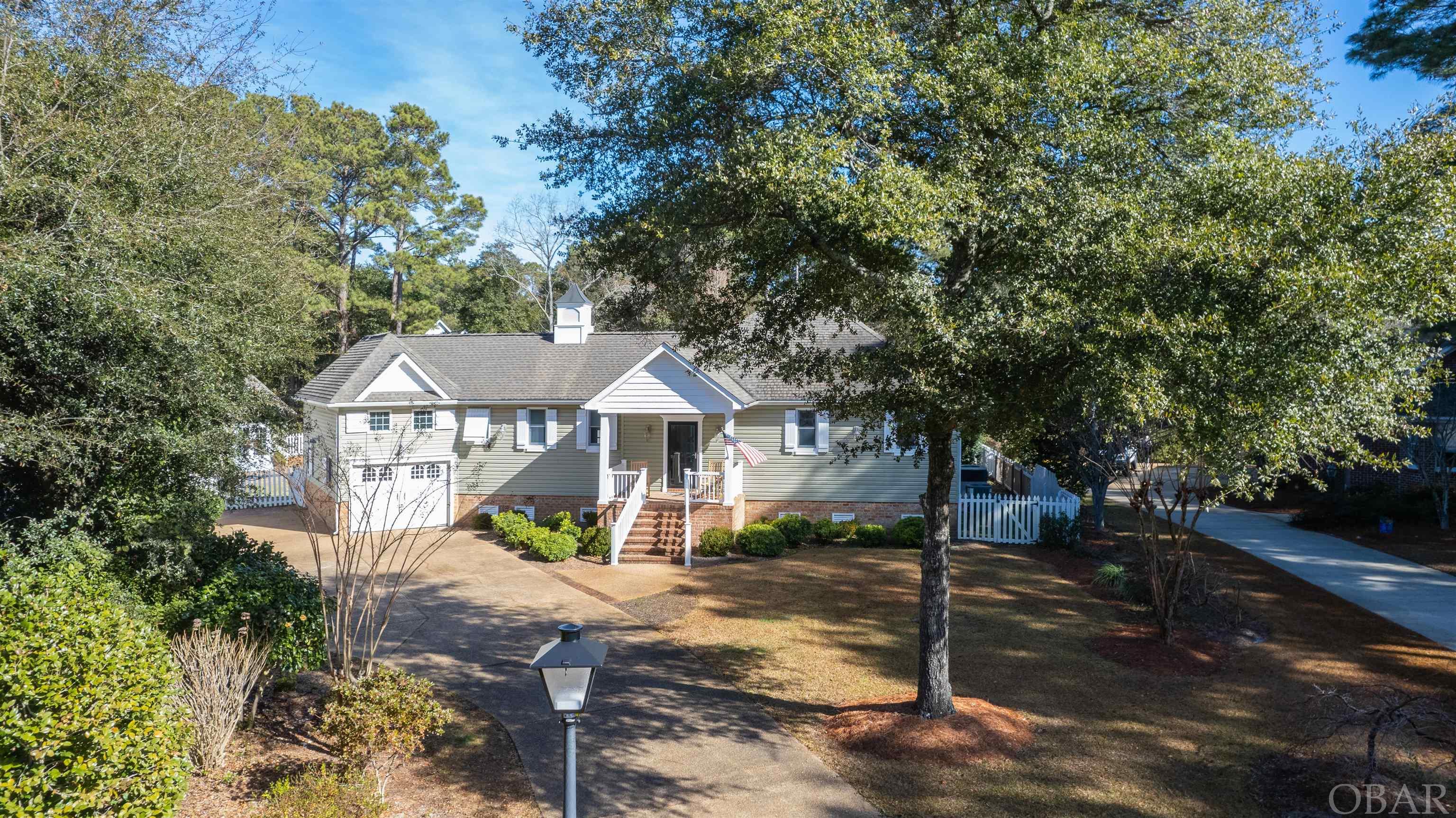 Located on the north end of Roanoke Island. In the Soundfront community of Heritage Point.  Situated on a fenced culture-de-sac lot, this home has large screened porch over looking the pool and private back yard. The non traditional floor plan has one-story living on one side and guest privacy on the other. Separated by an inviting foyer with a sightline to the back of the property, one side of the home features the kitchen with granite counters and island, powder room with pedestal sink, and a full laundry/utility room with pantry. Hickory floors carry from the kitchen into the spacious dining area with a built-in China cabinet, on into the open family room, and through double sweeping doors into the huge Primary en suite boasting 3 oversized cedar closets. The NEW large, private en suite bath with custom tile shower, free standing soaking tub, new floors and cabinets. Just off the bedroom via a glass door is additional storage or office. From the dining area to the back sitting room, glass sliding doors provide indirect natural light in the open are of the home.  The Pool was resurfaced in the summer 2021 with new salt system and heater.  Nothing left to do but enjoy!! A true one-of-a kind property, this special home would be ideal for retirement living or as a second home. Heritage Point offers a private pier, tennis courts, boat ramp and easy access to the multi-use path leading to Manteo. Close to shopping, dining, and historic Manteo, yet tucked far enough away from the hustle, this special home is one to surely create special memories.