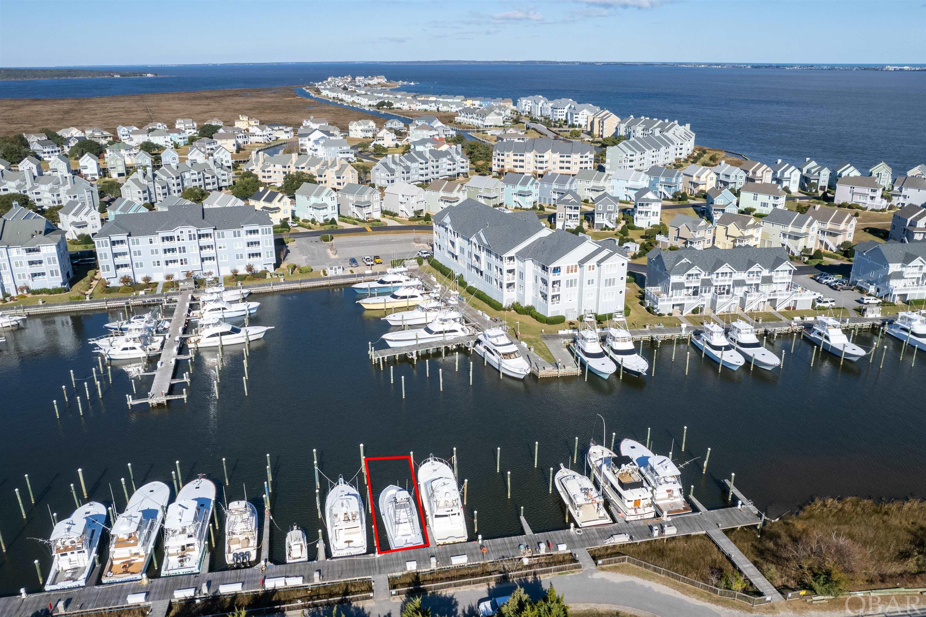 Located on E Dock, this 65FT x 21 W boat slip has location value with easy sound access and parking.  Pirate's Cove Marina is a protected, deep water, full service marina with 195 slips and a charter fleet of sport fish boats for offshore, nearshore and inlet fishing.  Pirate's Cove Marina is one of the largest world-class marinas on the East Coast with a high level of experienced charter sport fishing captains and crew. Pirate's Cove Marina offers: a fuel dock for non-ethanol gas and diesel, slips with in-slip fueling, private fish cleaning houses, showers, Ship's Store for light provisioning, an on-site full-service restaurant and Tiki Bar, and annual fishing tournaments.  Pirate's Cove Marina is approximately eight miles inside and north of Oregon Inlet via a deepwater, well-marked channel. The fixed bridge clearance of the Manteo/Nags Head causeway is 65 feet at mean high tide.