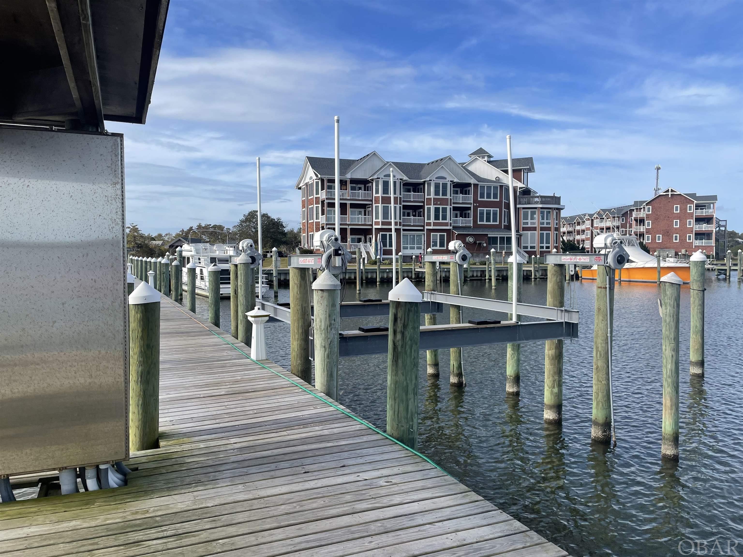 This is the boat slip you have been waiting for. Currently it is the only slip in Shallowbag Bay with a boat lift.  Lift is rated for a 30,000lb boat.  Slip is 18x40 and in the perfect location, easy access to the Roanoke sound and right next to the gazebo and picnic benches for spending lazy days at the marina. Shallowbag Bay Marina has a community pool, hot tub and fitness center with pool table and ping pong table. There's a ships store, shower facilities and Striper's restaurant. They also have a fish cleaning station, laundry facilities, pump out,  and 5 fueling stations providing "in slip" fueling to most boats.  Slip comes with two raised dock boxes. 1 bedroom condo for sale in the building right in front of boat slip.