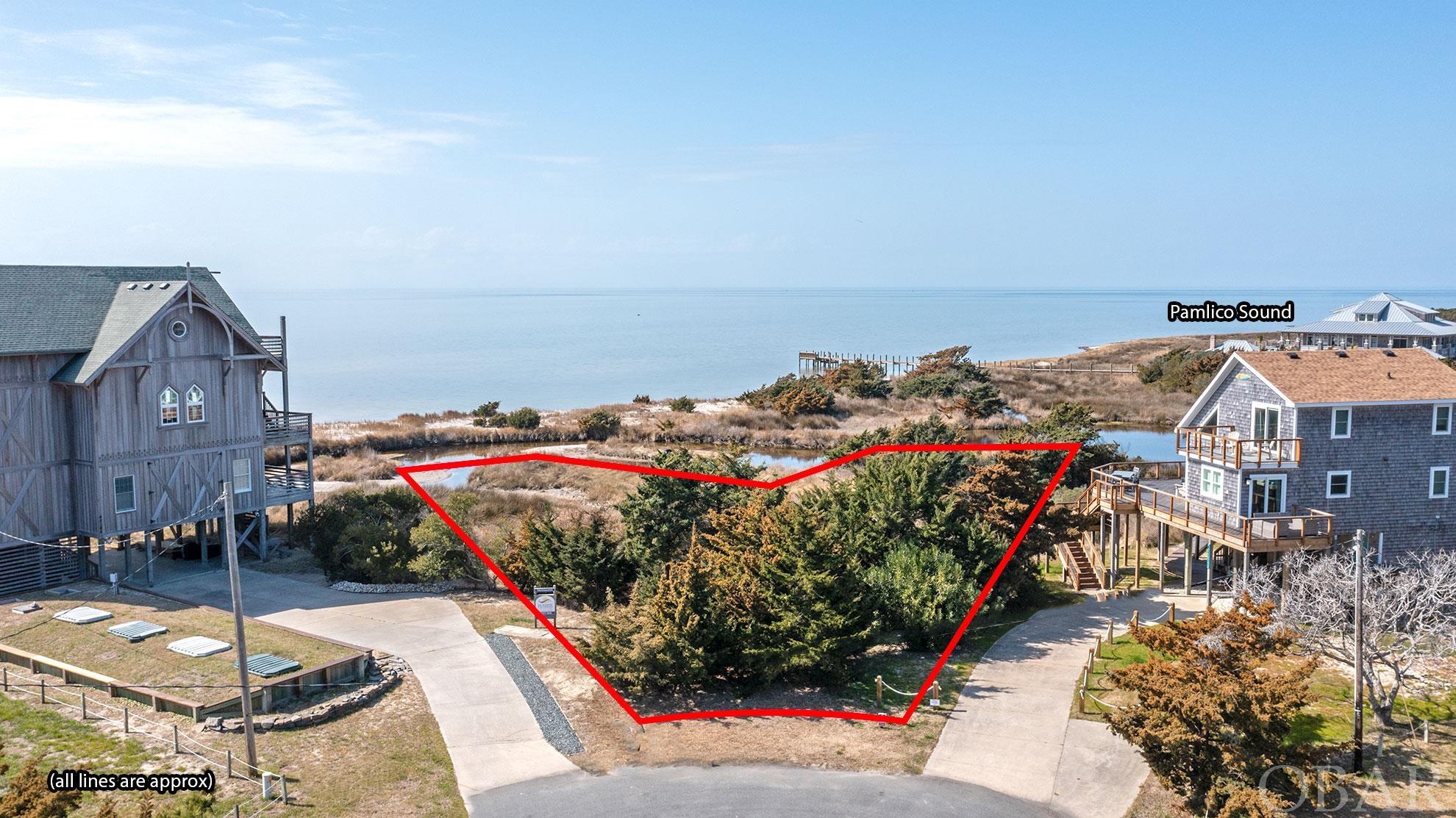 Nice sized basically sound-front lot with canal frontage as well. Almost directly on the white sand beaches of the sound with amazing sunset views. This lot sits on the end of the street so there will be little to no traffic. The canal on the back side of the lot connects to the Pamlico Sound and gives vast amounts of privacy and offers westward views towards the Sunset year round.  Almost bordering the state park reserve to the south by two lots this waterfront lot offers serenity and privacy. Only a two minute drive to the beach parking lot access and 4x4 ramp to the beach for those four wheel drive autos.  Come design your property and home the way you desire.