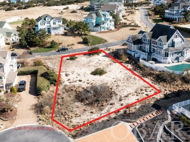 Beautiful build site perched on a highly elevated parcel and quiet cul-de-sac in the prestigious & gated Currituck Club Resort Community of Corolla. Enjoy the potential OCEAN VIEWS to be boasted from all levels of living in a future home built here. Offering an 18 hole golf course designed by the legendary Rees Jones and part of the ClubCorp family, the Currituck Club is surrounded by flawless grass greens, rolling dunes, seaside vegetation, and surrounding views of the Atlantic Ocean and Currituck Sound. Take advantage of all the additional amenities this community offers from a year-round fitness center, trash can roll-out/roll-back service, in-season pool operation for three different pools, in-season trolley service, and more!