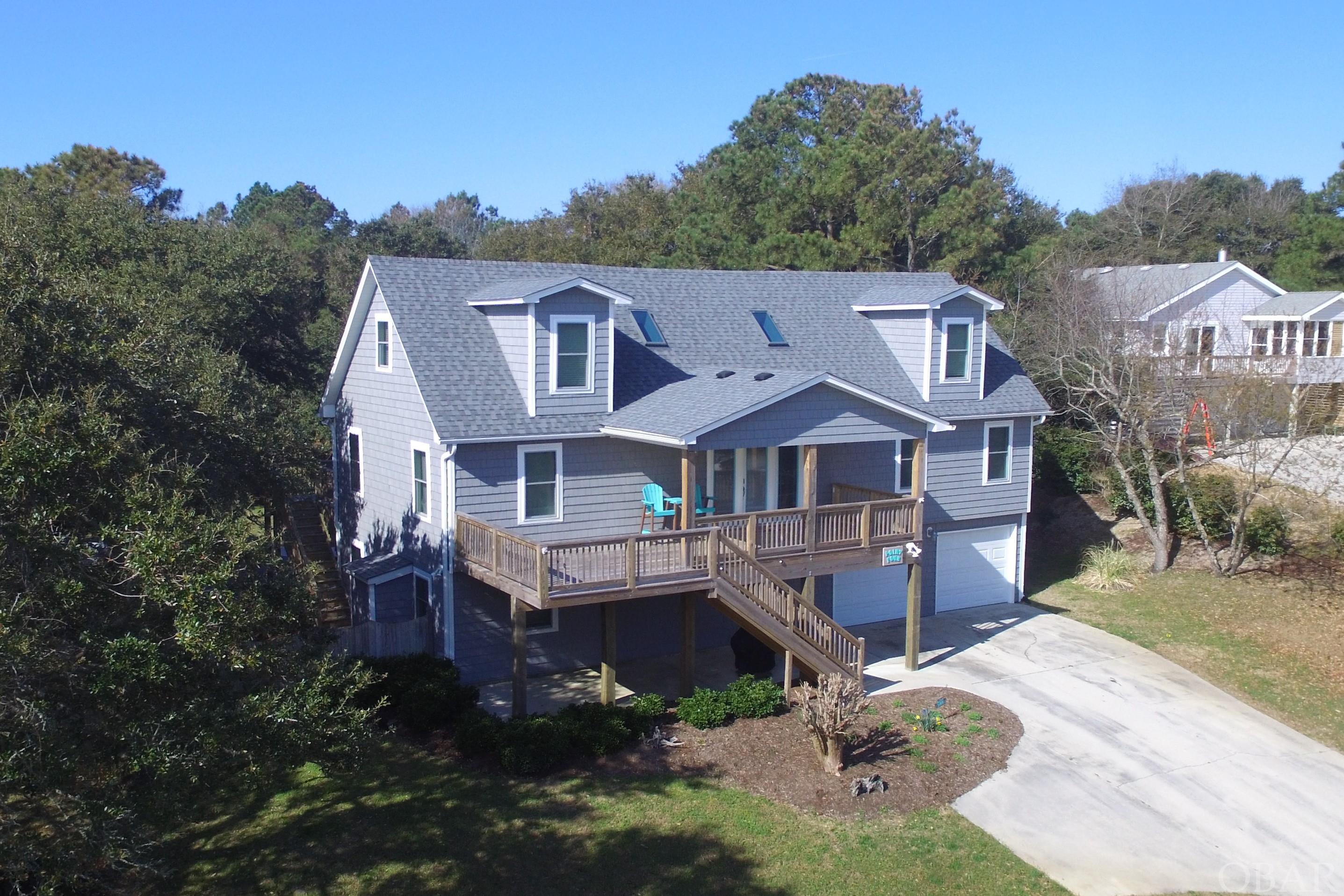 This second home is located in an ideal OBX location near both the ocean and sound accesses. Besides the location you'll love the high elevation, and large, private lot. The home was completely re-done on the outside as well as many new interior features. Many of these improvements were completed by one of the top builders on the Outer Banks, Sandmark Construction. These updates include impact resistant glass windows and sliding doors, a new roof and siding. Living room, kitchen the master bedroom, two other bedrooms and a bath are all on the mid-level so you can live on one floor. From the first-floor game room, you have quick access to the large pool with new vinyl liner, private back yard and two car garage.  The top floor has two super large bedrooms, a bath and a huge loft.  Sold mostly furnished, all this home needs are your own personal touches.  It would be a great second home, vacation rental or primary residence.  Ask your  agent for extensive list of information in Associated Documents.  This includes recent improvements, insurance info, survey, maintenace and utility expenses.