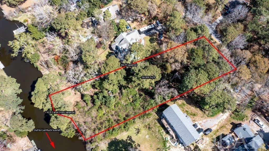 LARGE CANALFRONT LOT IN SOUTHERN SHORES (APPROX .75 ACRES) AND IN "X" FLOOD ZONE, SO LIKELY NO FLOOD INSURANCE REQUIRED *** GREAT LOCATION WITHIN THE SOUTHERN SHORES COMMUNITY ... NICE HOMES SURROUND, EVEN NICER NEIGHBORS! GREAT LOCATION ON WHICH TO BUILD YOUR DREAM HOME ... IMAGINE WALKING OUT YOUR BACK DOOR TO YOUR BOAT, AND THE QUICK RIDE OUT THROUGH THE MARINA TO CATCH THE CURRITUCK SOUND SUNSETS! *** FROM HERE YOU CAN ENJOY ALL THAT THE OUTER BANKS AREA HAS TO OFFER, AND YOU CAN START WITH ALL THAT IS OFFERED RIGHT HERE IN SOUTHERN SHORES ... DIRECT WALK DOWN EAST HICKORY TRAIL TO THE BEACH ACCESS, OR DIRECT WALK DOWN E. DOGWOOD TRAIL TO ANOTHER OCEANFRONT BEACH ACCESS, OR WALK DOWN ONE STREET, STROLL THE BEACH, THEN LOOP BACK ON THE OTHER STREET ... IT DOESN'T GET ANY BETTER THAN THAT! *** THERE ARE 3 BOAT MARINA'S (WITHIN QUICK WALK TO 2 OF THEM!) ... ONE WITH A BOAT RAMP * JOIN THE BOAT CLUB AND MAKE FRIENDS *** ADDITIONAL COMMUNITY INFORMATION: CLOSE TO BEACH ACCESSES * VISIT THE HILLCREST DRIVE APPROX. 100 PARKING SPACE BEACH ACCESS WITH NEW OPEN TRELLIS OUTDOOR SHOWERS, GAZEBO DECK, DUNE DECK, LIFEGUARD IN SUMMER * WONDERFUL IN SUMMER AND EVEN NICER OFF SEASON * YOU CAN WALK TO THE BEACH ACCESS AT HICKORY TRAIL IN 15-20 MINUTES OR SO *** MULTIPLE BOAT MARINAS, 2 SOUNDFRONT BEACH PARKS, DUNE AREA BASKETBALL COURT, PLAYPARK & SOCCER FIELD * OUTDOOR COMMUNITY TENNIS * TENNIS & BOAT CLUB/SLIPS ARE ADDITIONAL, BUT IT IS NOT REQUIRED TO HAVE BOAT CLUB MEMBERSHIP TO ACCESS THE BOAT RAMP *** THE SOUTHERN SHORES CIVIC ASSOCIATION (SSCA) IS OPTIONAL BUT COST ONLY ROUGHLY $60 PER YEAR SO EVERYONE JOINS * SIDEWALK THROUGH ENTIRE TOWN ALONG DUCK ROAD - GREAT FOR BIKING OR RUNNING *** DON'T WANT TO MISS SHOPPING IN NEARBY DUCK ... OR VISIT THE DUCK TOWN GREEN FOR THE ANNUAL OUTDOOR CONCERTS, OR THE NEWER SOUNDFRONT BOARDWALK *** KITTY HAWK STORES ARE ALSO CLOSE BY - YOU CAN GET TO STARBUCKS IN MINUTES! CLOSE TO WRIGHT MEMORIAL BRIDGE - YOU CAN GET THERE THROUGH THE BACK ROAD ... S. DOGWOOD TRAIL *** THE OUTER BANKS IS FILLED WITH EXCITING THINGS TO DO AND SEE ... THE OCEAN, LIGHTHOUSES, WRIGHT BROTHERS MONUMENT, THE LOST COLONY, CAPE HATTERAS NATIONAL SEASHORE, CAROLINA BLUE SKIES, AMAZING SUNSETS & SO MUCH MORE. ARE YOU THINKING ABOUT LIVING THE DREAM? PURCHASE LOT NOW AND BUILD, AND GET STARTED ... OR, PURCHASE NOW AND HOLD FOR FUTURE PLANS ... THIS IS A GREAT TIME TO ENTER THE MARKET! THERE IS AN OLD SHED ON THE PROPERTY NEAR WHAT USED TO BE A FENCED GARDEN AREA * LAND IS LARGER THAN MOST CANAL LOTS IN SOUTHERN SHORES MEASURING APPROXIMATELY 100 FEET X 330 FEET (33,102 SQUARE FEET OR .75 ACRES) ... THE LOCATION IS WORTHY OF A HOME OF SIZE - PLENTY OF ROOM TO DESIGN A HOME W/ POOL * THERE SHOULD BE AN OLD PATH ON THE PROPERTY STARTING ON THE SOUTH END OF THE STREET FRONTAGE W/ ACCESS TO REAR OF LOT AT CANAL *** LOCATION IS EXCELLENT * COME SEE!