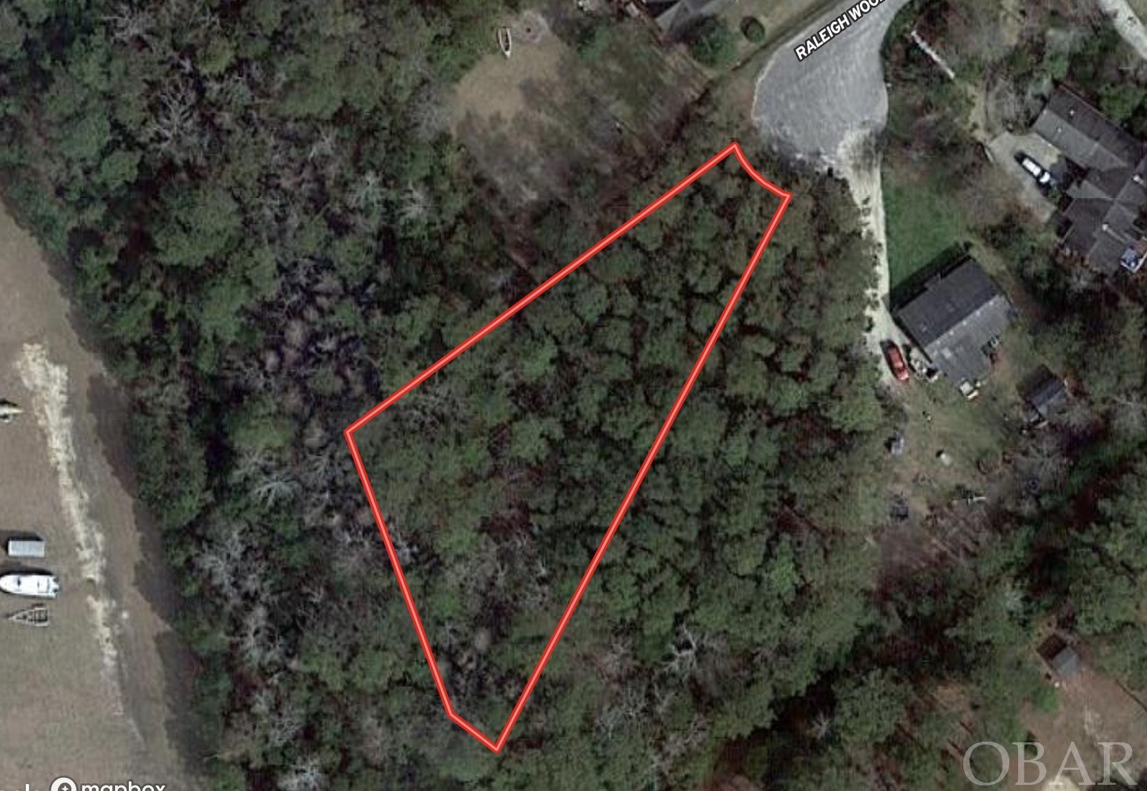 .61 Acre Lot in X Flood Zone, Great Neighborhood. Close proximity to Elizabethan Gardens, NC Aquarium, and downtown Manteo!  This lot is located at the end of Raleigh Wood Dr. in the cul de sac.  County water is in place. Lot will require private septic.  Access to community pool.  Water tap fees have been paid.
