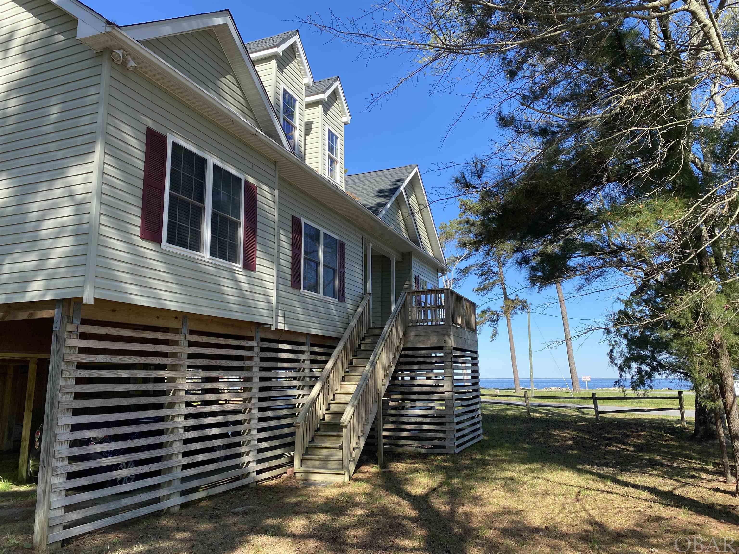 Spectacular Sound Views at this Semi-Waterfront Home near the Outer Banks!  Enjoy water views from every room (except the laundry room). Located less than 1 hour from the white sandy beaches of the Outer Banks, 45 minutes to Manteo, and 10 minutes to downtown Columbia, NC. This spacious modular home will make a great primary residence or a second home that is away from the hustle and bustle. The main level has three bedrooms and two full baths. The unfinished upstairs is ready for a huge bonus area with amazing water views. Sitting high and dry on pilings, with a dry entrance makes unloading the car is a breeze. Tyrrell county has amazing fishing, hunting, animal watching, boating and other outdoor recreation opportunities as well as being home to the Pocosin Arts School of Fine Craft. This property is just behind the American Legion and has mostly unobstructed views of the Albemarle Sound. NEW; water heater, roof, HVAC. All appliances convey. So much to offer!