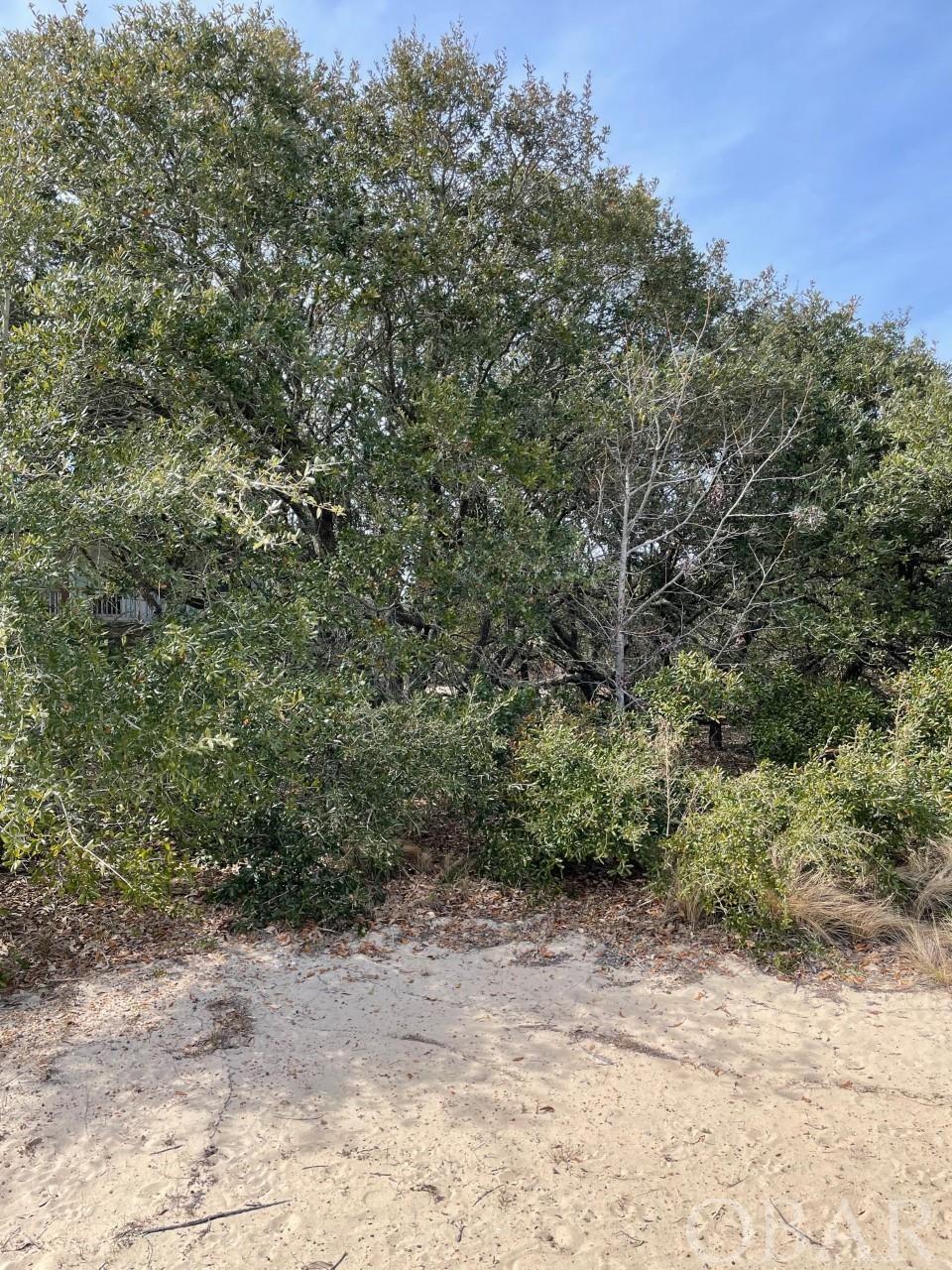 This unique lot in Ocean Sands is located in a quiet cul-de-sac in Section N. What is so unique about it? It is right next to the path that will take you to the beach access. It takes about 3 minutes to get to the beach! No neighbors right behind you and you may even have ocean views. This is a perfect spot to build your beach dream house. The lot is in X flood zone, which means that flood insurance will not be required. Ocean Sands has miles of wide, soft-sandy, lifeguarded beaches. Location is perfect with close proximity to the grocery store, shopping and numerous activities that Corolla has to offer including wild horse tours, Currituck Club Golf Course and Corolla Light Lighthouse.