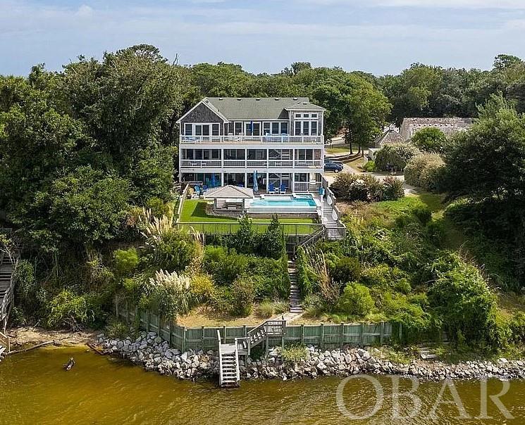 Turnkey soundfront home, perfect location, superior water and sunset views from all three levels. Kayack, paddle board or fish on the sound and use your deeded beach access to spend days at the beach. Five minute walk via the multi-use path into the town of Duck for shopping, dining and recreation. Top level sun room, mid-level office and ground level game room. Heated infinity pool with swim-up Tiki bar, hot tub and outdoor speakers.
