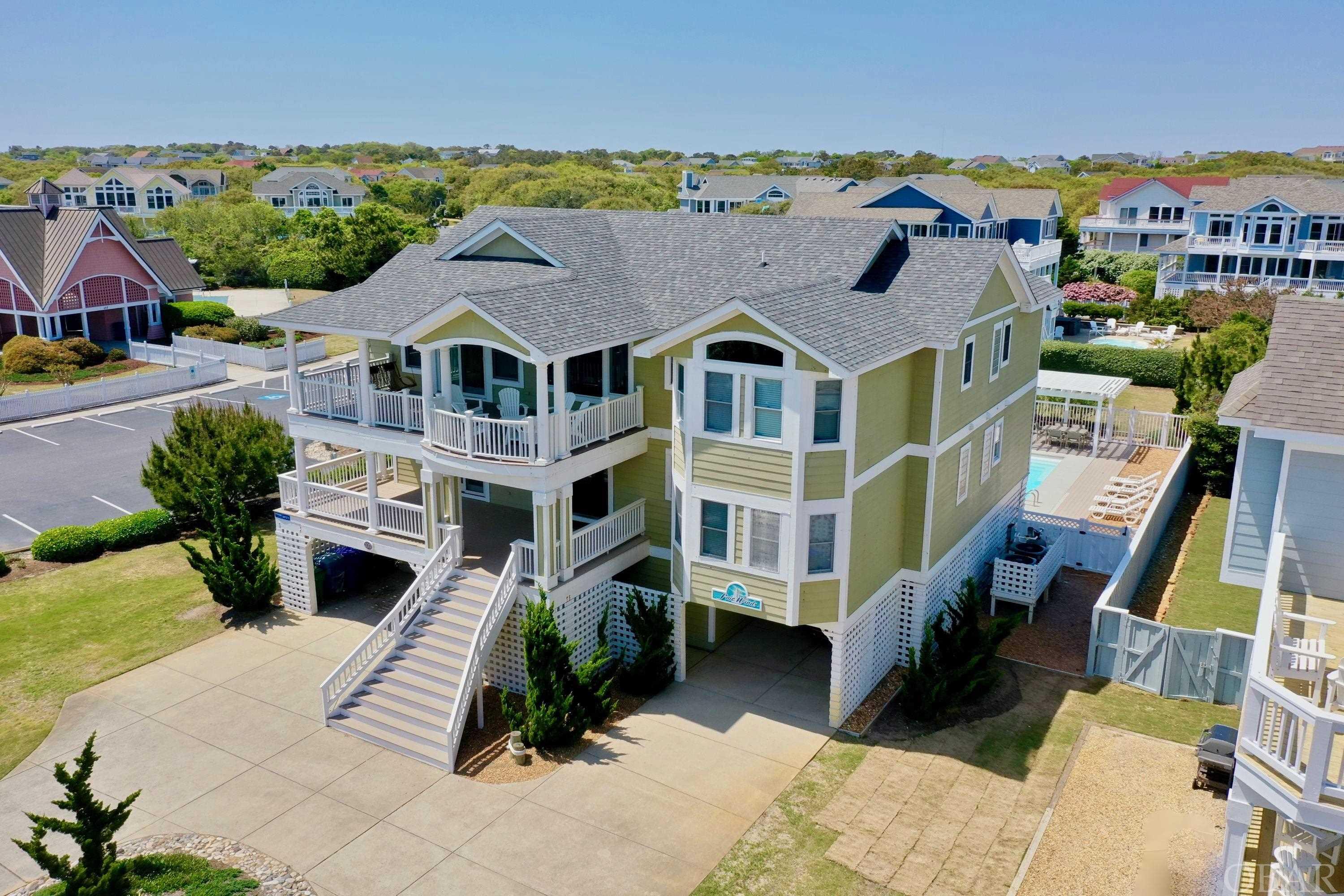This is the one you have been waiting for! Located on a coveted 1/2 acre homesite in the exclusive community of Four Seasons. The semi-oceanfront location boasts a direct beach access, stunning ocean views, a large backyard perfect for an event tent, and sits on a private cul de sac with only 4 homes. Enjoy amazing ocean views without the risk and maintenance of oceanfront. This luxury 7 bedroom (5 are private En-suites), 7.5 bath retreat home has been lovingly maintained and meticulously cared for. Boasting an open functional floor plan with plenty of room to spread out, private bath access from all 7 bedrooms, multiple gathering areas, wrap around decks, renovated chef's kitchen (2018), tankless water heater, a large 15x33 private pool with pergola and outdoor kitchen, irrigation, new carpet and LVT Flooring throughout (2018), New Trex decking on the westside of the top and mid-level (2020), new roof (2020), 2 new HVAC systems in 2021, fresh exterior paint to be completed in May, a new irrigation pump (May 2022, $2,000.00), and more. See seller upgrades in associated docs. The top level features a grand great room with soothing coastal colors, electric fireplace, vaulted ceilings, of course ocean views, large dining room, Luxury Vinyl Tile, a reading nook/office, freshly renovated kitchen, a powder bath, and 2 Primary bedrooms. The "to die for" Kozy Kitchens design features; soft-close custom cabinets, stainless steel appliances including a dual zoned wine refrigerator for wine and canned beverages, glass tile backsplash, eat -in bar with lots of storage, Quartz countertops, and a spacious pantry. The great room is perfect for entertaining large family gatherings. There are two ensuite bedrooms with private baths, one with a walk-in tile shower and separate water closet. One bedroom has a private deck access and the other gorgeous ocean views. The mid-level includes 5 more bedrooms, the main entry, and the utility room with a laundry sink. Three of the five bedrooms are primary bedrooms with private baths. The 2 king bedrooms have a walk-in tile shower, and double vanity. The 5th primary bedroom has two duo bunk sets with a private bath and deck access. The remaining two bedrooms share a jack and jill bath. The lower level has a huge media room with surround sound, a large TV, and plenty of comfortable seating. The game room features kitchenette with a full size fridge, microwave, and custom cabinetry with lots of storage. This room also has direct access to the outdoor living space where adults and children love to play. There's an ample sized pergola offering plenty of shade, an outdoor kitchen complete with a gas grill, an outdoor shower, a sand volleyball court, and a huge lush green open space perfect for a tent where you can have large weddings or special events. This house has it all and the sellers have thought of everything. The Four Seasons Community has a lot offer in amenities and help make the rental income in the shoulder season a winner. Enjoy the large outdoor community pool that is close by, the indoor pool and fitness center, the out tennis courts, play ground, and trolley system. The house is rented from March to October so the only time to see it is on Sunday, the turnover day. Sellers have lots of repeat rentals and could be more aggressive on weekly rates. Exterior will be freshly painted in May. For aerial drone video copy and paste the following link: https://youtu.be/AXn9j4WNmBU ; For 3D Virtual Tour copy and paste the following link: https://my.matterport.com/show/?m=UwDsPfA2N2Z&mls=1