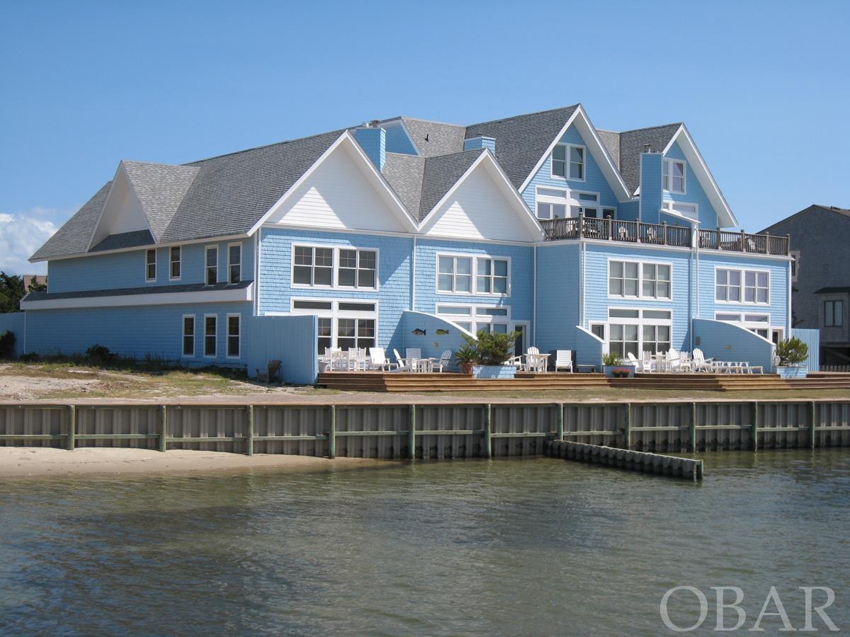 A 2 bedroom/2 full bath, 2-level waterfront condo in the Horizon Condominium's. Located in the coveted Windmill Point area of the island with beautiful views of the Pamlico Sound and breath taking sunsets! A large deck facing the sound is a wonderful place to relax and watch the fishing boats, ferries and water sports. A shallow water dock is available for easy water access for kayaking, clamming, crabbing, swimming or light fishing. Open kitchen/dining/living area, tiled floors in the gathering areas and carpet in the bedrooms, cathedral ceiling in the living area, juniper wood accent wall in the L/R and ceiling fans. There is a 2nd floor gracious loft area, plenty of closet space and vaulted ceilings in one bedroom and bath. The downstairs bedroom has sliding glass doors to a small deck; both bedrooms have a distant view of the lighthouse. Bathrooms have oversized Jacuzzi tubs and separate showers. Proven rental history. Exterior maintenance to be done as contractors schedule permits.