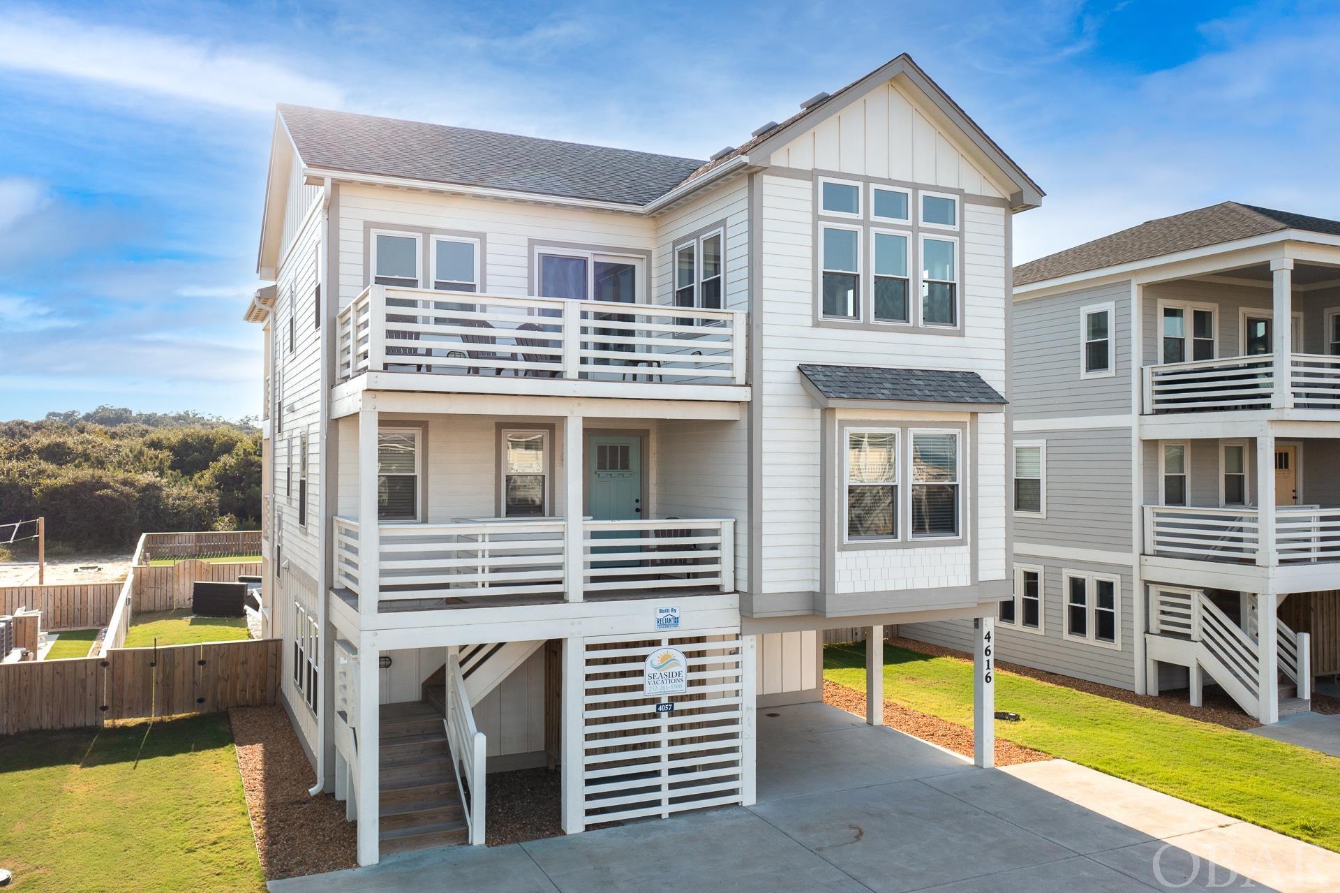 Can't beat location with impressive income in the heart of Kitty Hawk on the Outer Banks. This 6 bed 6.5 bath rental home, built in 2019, is just steps from the beach with great ocean views from the top living level and room for the whole family to enjoy with a spacious layout and vaulted ceilings. Kitchen features stainless steal appliances, quartz counters and able seating. Primary King suite is located on the top level with an additional four bedroom w/ ensuite on the mid level. Game-room w/ pool table, wet bar and flat screen tv, sixth bedroom and additional sitting room with pull out sofa are all located of the first floor. Ground floor also features elevator access, carport, 16’x16’ Private Pool, outdoor patio area w/ bluetooth-enabled smart TV, hot Tub, fenced yard.