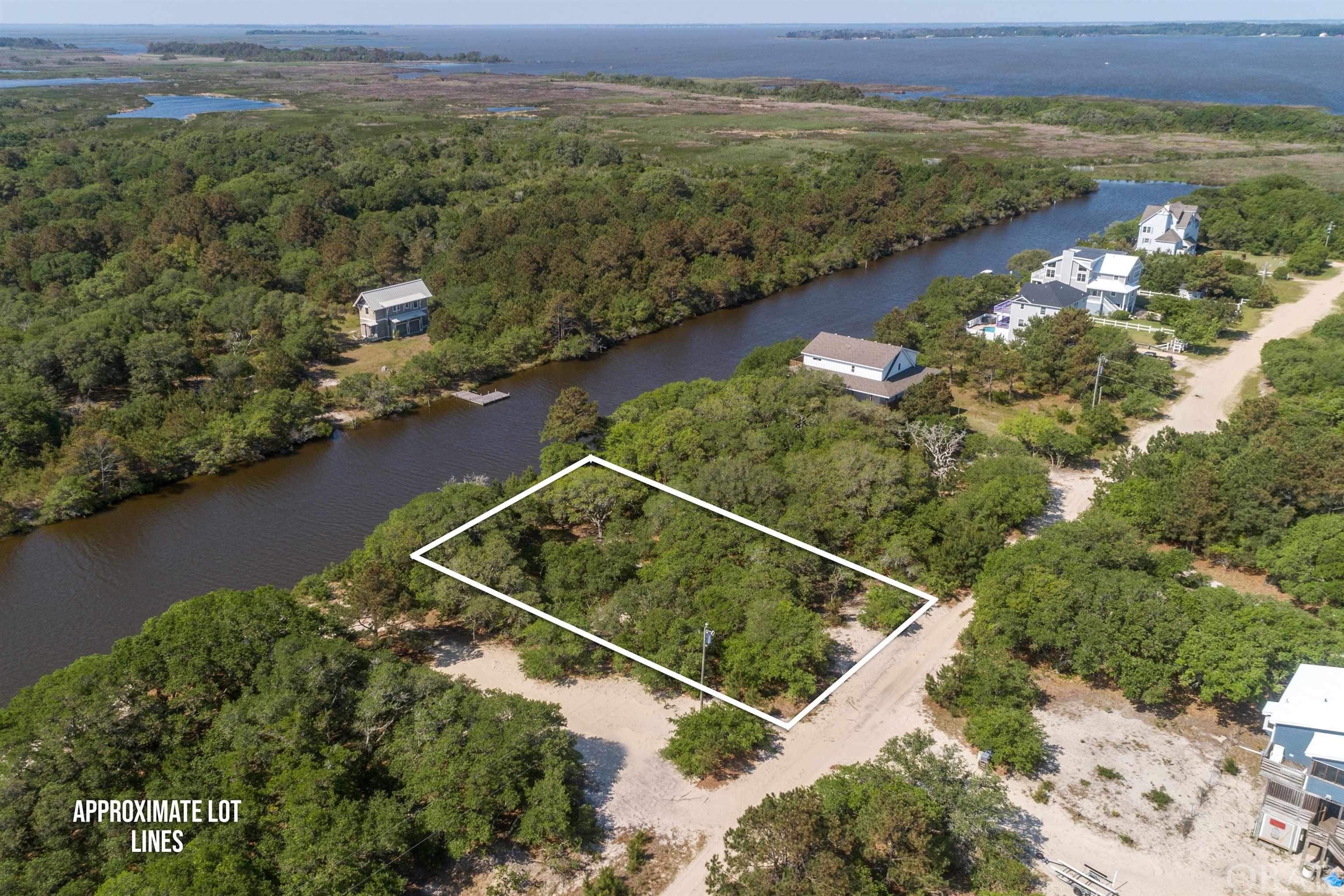 Beautiful Carova Beach Canal Front lot to build your home near the beach plus quick access to the Sound. Here is the lot that you have been waiting for and it is just a short distance to the Beach.  This lot offers Water Views and privacy overlooking the Views of the Wildlife Preserve plus additional privacy, as the lot is located near the end of a dead end road. The Carova Beach Park and Boat Ramp are close by on the corner of Ocean Pearl Road and Scoter Road.  If you are looking for a Lot with privacy on a canal, southern exposure and a short distance to the beach to build your home, then this is the lot for you.  Call now to schedule a showing of this lot located in the 4 Wheel Drive Area of Corolla.