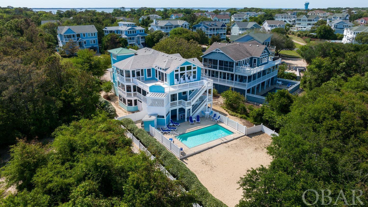 Stunning coastal retreat in the heart of Duck in the coveted Four Seasons Community. Extremely well maintained and updated, this home is full of upgrades and everything you would expect in a high end home. Located at the end of a cul-de-sac, enjoy a large (~17,000 sq ft) lot and direct beach access via the community walkway next to the house that takes you straight out to the beach! Professionally decorated with new furniture throughout, a remodeled kitchen with all new GE appliances, new interior and exterior paint, new expanded fencing giving you a completely fenced in back yard, a huge storage room added under the house, new pool heater for the large 14' x 28' salt water pool, and more! This 6 bedroom home is comfortable and welcoming, a smart rental investment or second home, complete with a private elevator to take you to each level and even handicap friendly amenities throughout. Outside, enjoy spacious decks on each level, hot tub, two outdoor showers, and plenty of parking.  Being in Four Seasons, you'll appreciate all the amenities including a clubhouse with indoor pool and gym, tennis courts, trolley service in the summer, and oceanside community pool, and sound access with dock.