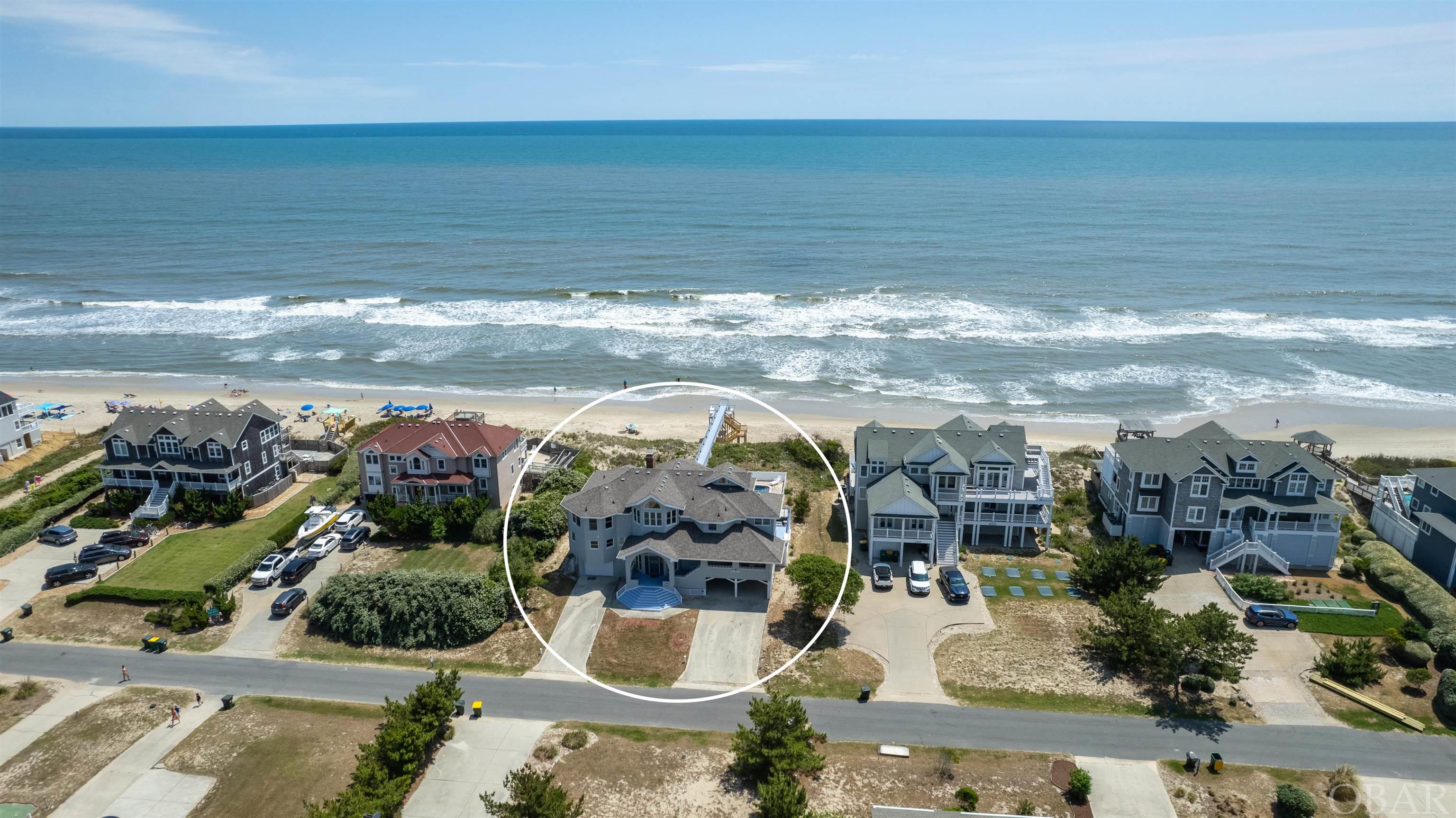 Unique Oceanfront Estate with Magnificent Ocean Views. This Craftsman-Style Cottage is situated on a Elevated 28,000 Sq Ft Lot and in an X Flood Zone! (Flood Insurance optional) Custom architectural woodwork, including stunning antique heart Pine "peg" wood floors. Designed to capture views of the Atlantic Ocean on every level. Step into the impressive 3-story Foyer with custom Juniper wood ceilings, plantation shutters, & showcasing wide custom wood stairs with Fir handrails, that lead to an open floor plan. The great room offers 2 stories of soaring windows with ocean views, Cypress wood cathedral ceilings and an impressive stone, gas fireplace, with an oceanside Catwalk -- a RARE feature -- that leads to an oceanside balcony. Gaze at the ocean from the gourmet kitchen with large kitchen island and Oak floors, gas countertop range, plantation shutters, and beautiful Spanish tile. You will also find custom cabinetry and bar for entertaining guests. Enter the massive Master Suite through arched doorways, offering an ocean-view sitting area. The impressive Master Bathroom features a clawfoot tub, double vanity, & a spacious tiled, glass shower with a teak bench, cedar lined closets, and Bidet. All of the other bedrooms and bathrooms are spacious, with large closets and room for expansion. Relax & enjoy the Ocean breeze from your Private Pool (Installed 2018), Hot Tub (2018), Covered Decks, and Personal Beach Boardwalk (recently remodeled). Notable features include a Ship's Watch on the 4th floor, with private balcony and rooftop deck, offering spectacular ocean views, plantation shutters that are found throughout the home, custom woodwork, arched doors, and an oversized garage/workshop, that could be made into a Game Room. Located in the desirable Ocean Hill subdivision. Did I mention, it is SOLD FURNISHED!!! New Trane HVACs Installed 2019 & 2022. New Septic System 2017. New Anderson windows 2022, new gas fireplace 2022, exterior painted 2022, new hot water heaters 2022. Decks repaired and painted, 2022. Confirmed Room for Elevator. Projected to generate $225,000. ***Already booked over $152,000. for 2023 season!