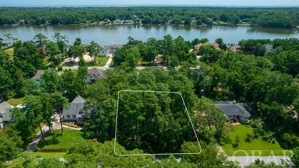 Gorgeous Semi-soundfront lot in a beautiful gated community of Martins Point for sale. Located toward the point, this lot has an excellent location. Close to the marina and boat ramp, park, lake and with a view! Martins Point has so much to offer. Make this your permanent homesite or second home away from home! The community is situated on a 335 acre strip of land, about 2 1/2 miles long and only about 1/2 mile wide,  bordering the Currituck Sound and Guingite Creek.  Complete with 24 hour gated security, a marina, boat launch area, playgrounds and more, there are activities for all—including optional membership in the Martins Point Yacht Club.