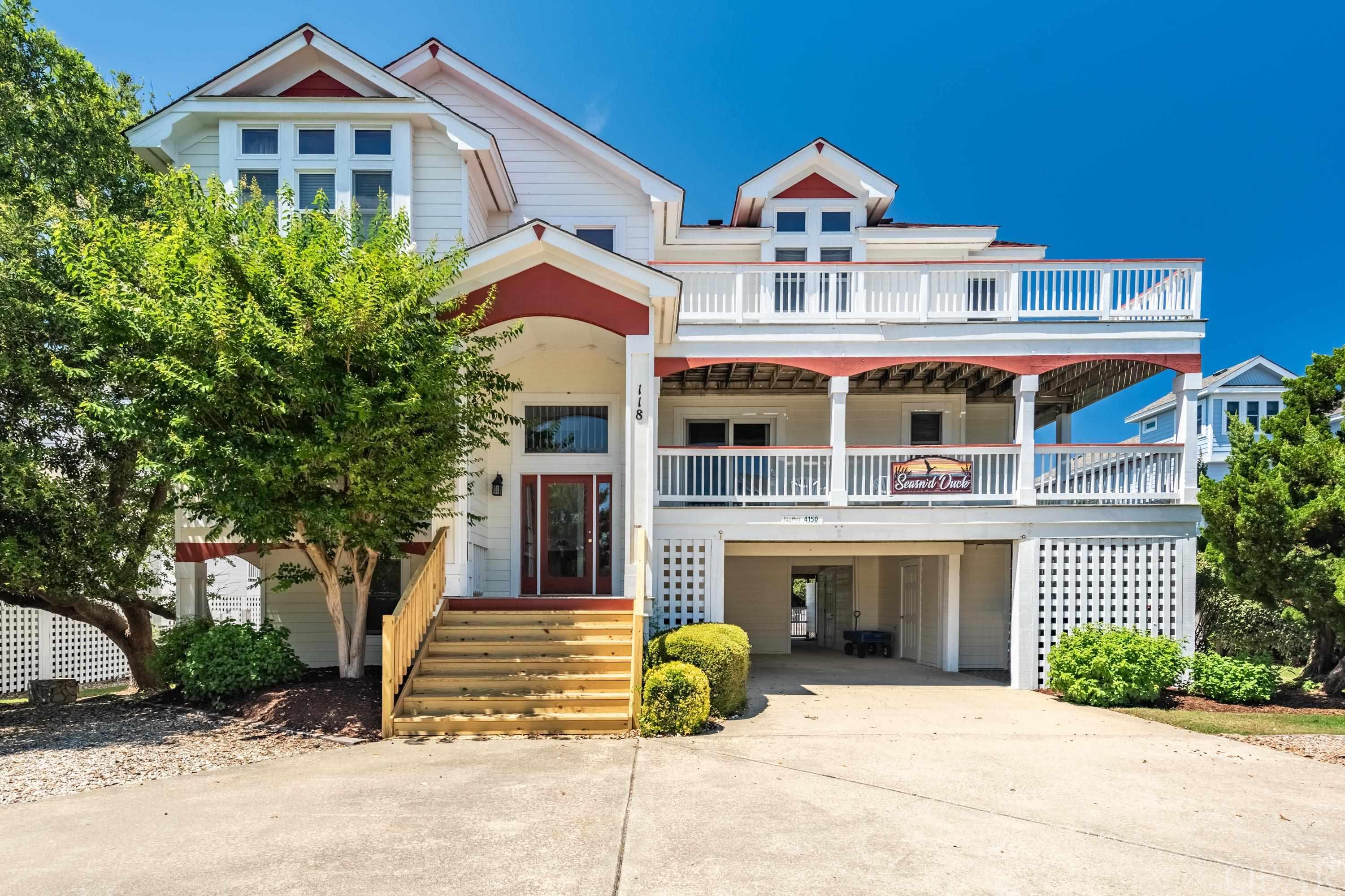 This vibrant 8-bedroom Duck home has attracted guests for years with its wonderful location, community amenities and warm interior. This cottage offers a welcoming place to entertain and enjoy time together on the Outer Banks. Located in the Four Seasons community, this home is within walking distance to the unique shopping and dining areas of downtown Duck and soundfront boardwalk.   Just on the other side of the back yard fence is a shaded concrete path that leads to Lala Court where the beach access is located. New owners can immediately move in and start enjoying the charms of living in Duck. The home has a warm appeal with its sunny exterior, large light reflecting windows and sliders, allowing natural light to pour in. On the top level is a great room with soaring cathedral ceilings, sparkling white walls, gas fireplace and powder room. A well-equipped kitchen with cooktop, a range/oven, large refrigerator, 2 dishwashers and ice maker. Solid surface countertops and island provide a wonderful prep area and additional seating. This open concept space also includes room for a dining area and breakfast nook.  Unique design with 2 primary en-suite bedrooms on the top floor.  The mid-level hosts 3 en-suite bedrooms with private bathrooms and deck access, plus one bedroom that shares bath with den.  Deck can be accessed from den.  Washer and Dryer are conveniently located on this level.  Downstairs is a wonderful rec room with pool table, TV, wet bar with refrigerator and microwave. 2 Additional bedrooms and hall bath. Entertaining is made easy outdoors with the large 16’ X 34’ pool, hot tub, volleyball court, child’s playhouse, outdoor shower with toilet, a basketball hoop in the front of the house.  Improvements include:  new roof at the beginning of 2020, new pool liner 2021, some new pool furniture last year (2021). Most Kitchen appliances were replaced in 2018 and 2019 except for cooktop. Microwave being replaced this week.  Hot tub, both water heaters and 2 of the 3 air conditioning units were replaced when the house was first bought  (2016).   Community amenities include clubhouse with rec room, fitness center, indoor pool, outdoor pool, tennis court, soundside pier.  Trolley during Summer