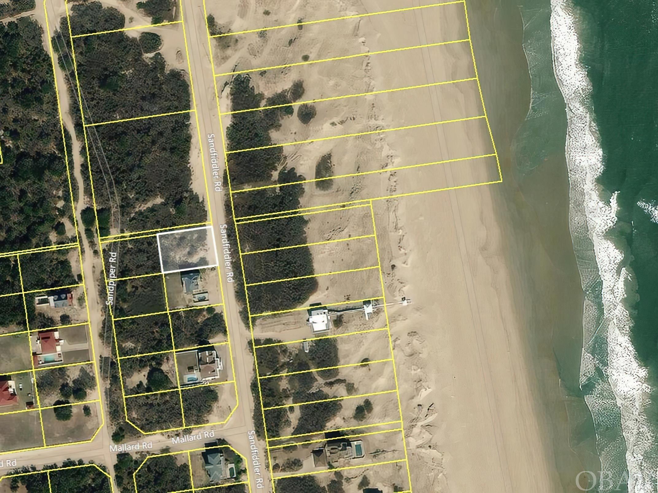 A beautiful Semi-Oceanfront home site in Carova Beach that doesn't have a lot of houses in front of it. Located near the heart of Carova Beach by the fire station ramp access and with a 10ft easement to the giving you a lager buffer from your neighbor to the north. Walk to the beach, or hop in you ATV and scoot on over to the park This lot has a lot of possibilities. Just pick your plans, build your house, and enjoy the views!  Between the Dolphins swimming in the ocean, the pelicans gliding through the air, and the Corolla Wild Horses grazing on the Dunes what's not to love about Carova Beach.