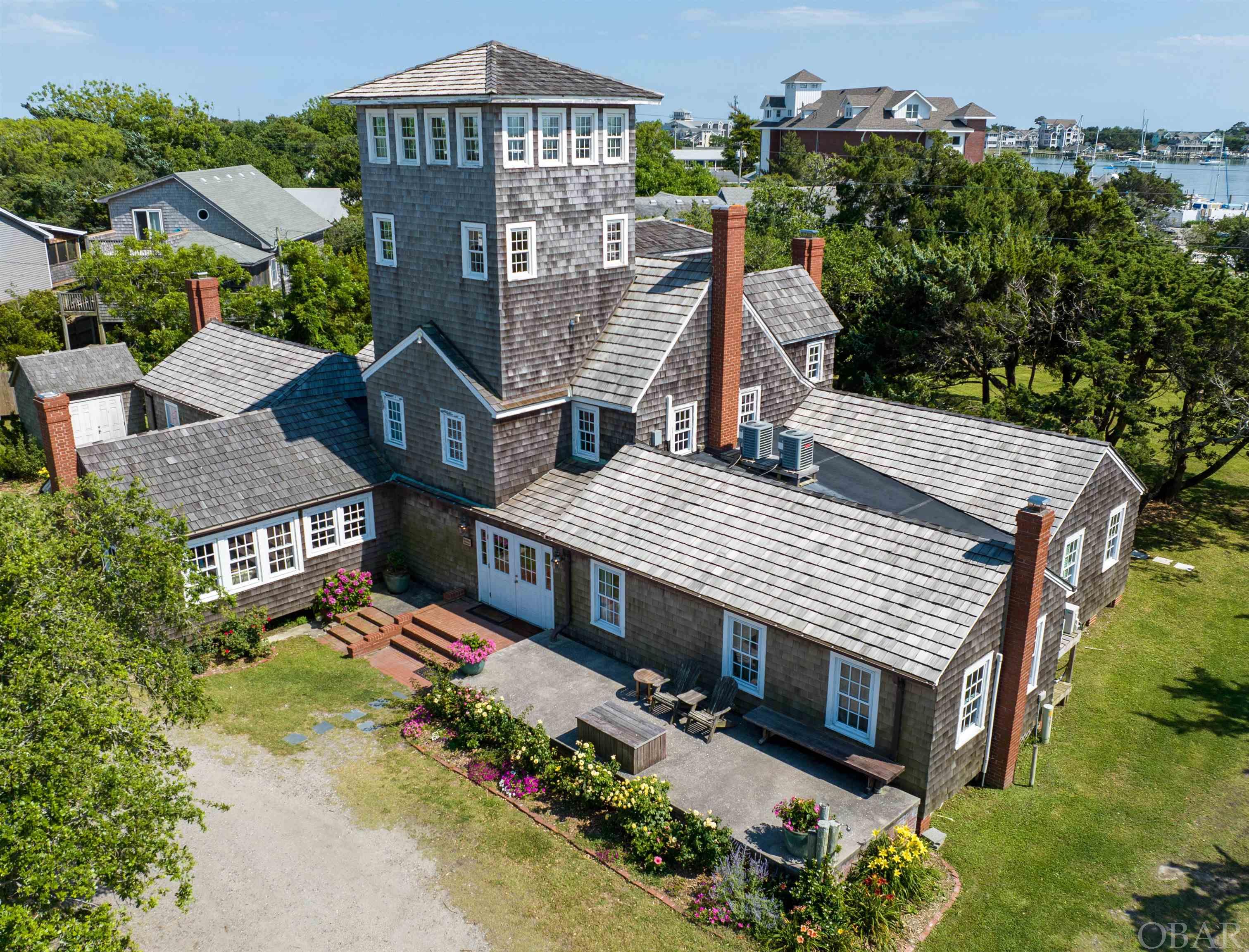 The Berkley brings Ocracoke home. Encompassing nearly 2.5 acres, a village concept building plan combining lodging, retail, dining, event services, and community gatherings brings Ocracoke back to its origin - Silver Lake Harbor. The Berkley village would be a destination for all visitors, including the 600-700 daily passengers aboard the Ocracoke Express Ferry. Existing infrastructure includes the 6 bedroom, 5 1/2 bathroom Manor, 6 bedroom 4 bathroom Suites, the Berkley Barn wedding and event center, and water and septic to accommodate expansion.  The 5,810 sq ft Manor was built by legend Sam Jones with exquisite woodworking and a flair for design. It includes 6bd/5 1/2ba, a commercial kitchen, 25 seat dining room, 4 cozy fireplaces, and was meticulously renovated in 2012.  The Suites, built in 2017, contain 6br/4ba across 2,640 sq ft with a full kitchen, dining and living room. A destination accommodation that enhances the Berkley experience. The Barn, a focal point for all celebrations in the community, weddings, and reunions, is Northeastern North Carolina's premier wedding center and is solidly booked through 2022 and 2023.  Matterport 3D tours are available for all three buildings by using the links at the end of the description.  Three additional residential/commercial lots encompassing nearly 30,000 sq ft with existing septic are available to be used as restaurants, retail shops, condos, or residential.   Community septic on site can accommodate an additional 24 bedrooms. Lots 3, 4, 5, & 6 are included.   Manor: https://my.matterport.com/show/?m=q1YKGozZt8A Suites: https://my.matterport.com/show/?m=YNLmPVa7EAn Barn: https://my.matterport.com/show/?m=KxZqsx6ed7G