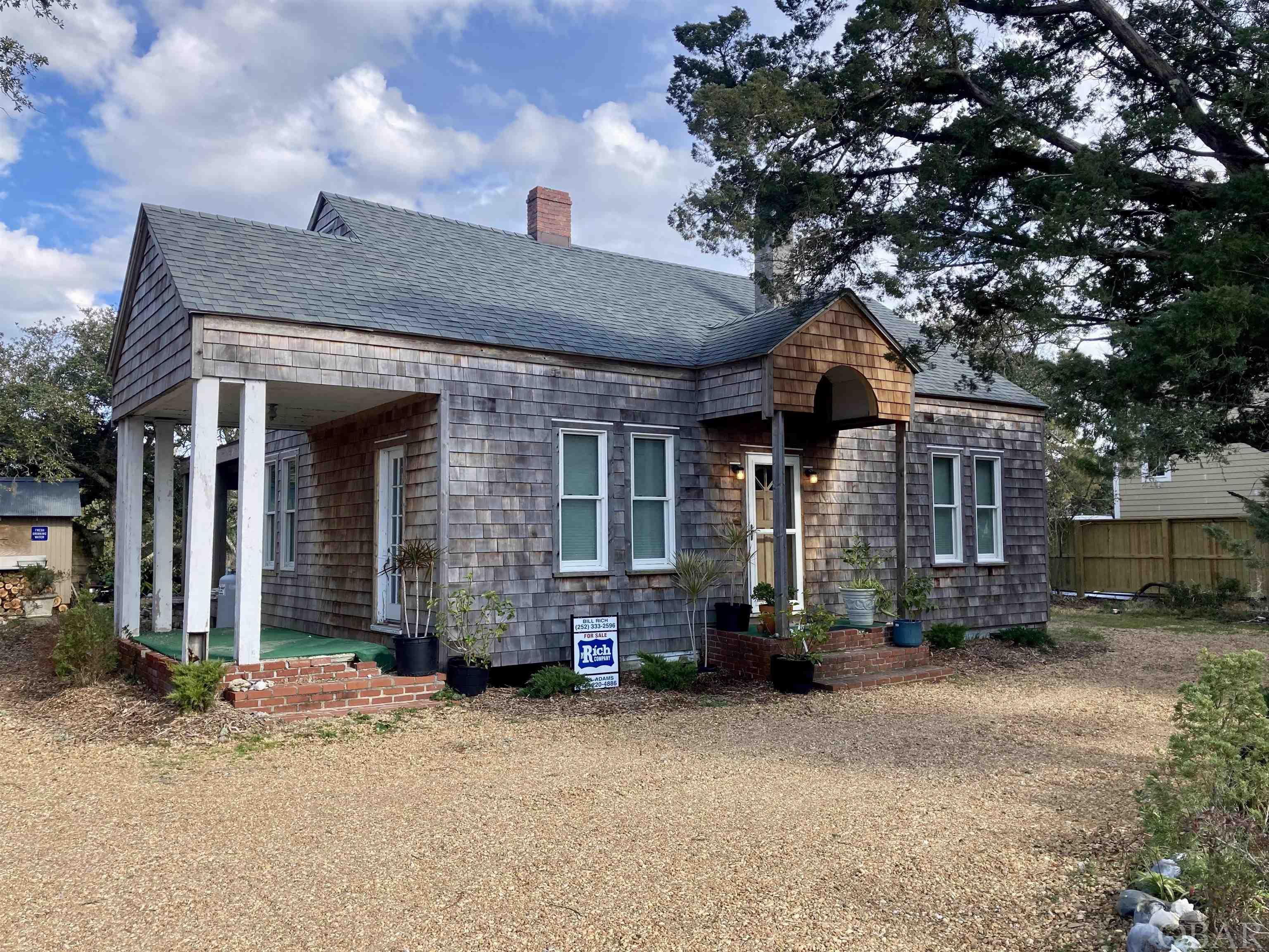 This historic Ocracoke home was recently remodeled inside and out and boasts meticulously cared for gardens. Brand new cedar shake siding, wood floors, appliances, impact glass double hung Pella windows, insulation, electrical, and travertine tile and teak bathroom. An expansive living area welcomes you through the front door and empties onto an idyllic back porch that is perfect for relaxing and hosting. Within short walking distance of coffee shops, the harbor, and Ocracoke's finest restaurants. This home would make an excellent vacation rental or year-round residence. Large lot of over 8,000 sq ft. Upstairs is currently being finished creating a master suite with full bath and a large private balcony. The entire house is also being upgraded with the addition of central air and heat.  Other upgrades include a new roof in 2017 and new hot water heater. A new 3 bedroom septic system is currently being installed. This home is approved on the FEMA list to be raised and this can be transferred to the buyer at closing.