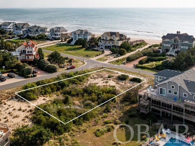 Location! Location! Location! Rare opportunity to build the home of your absolute dreams on this spacious corner parcel situated in the heart of the Ocean Hill community of Corolla. Views of the Atlantic are yours to enjoy from a future build on this 22,000 square foot lot offering direct access to the beautiful beaches of Corolla just across the street. Enjoy the convenience of local shops & restaurants, the Historic Corolla Village, and Currituck Beach Lighthouse just a short walk or bike ride away!
