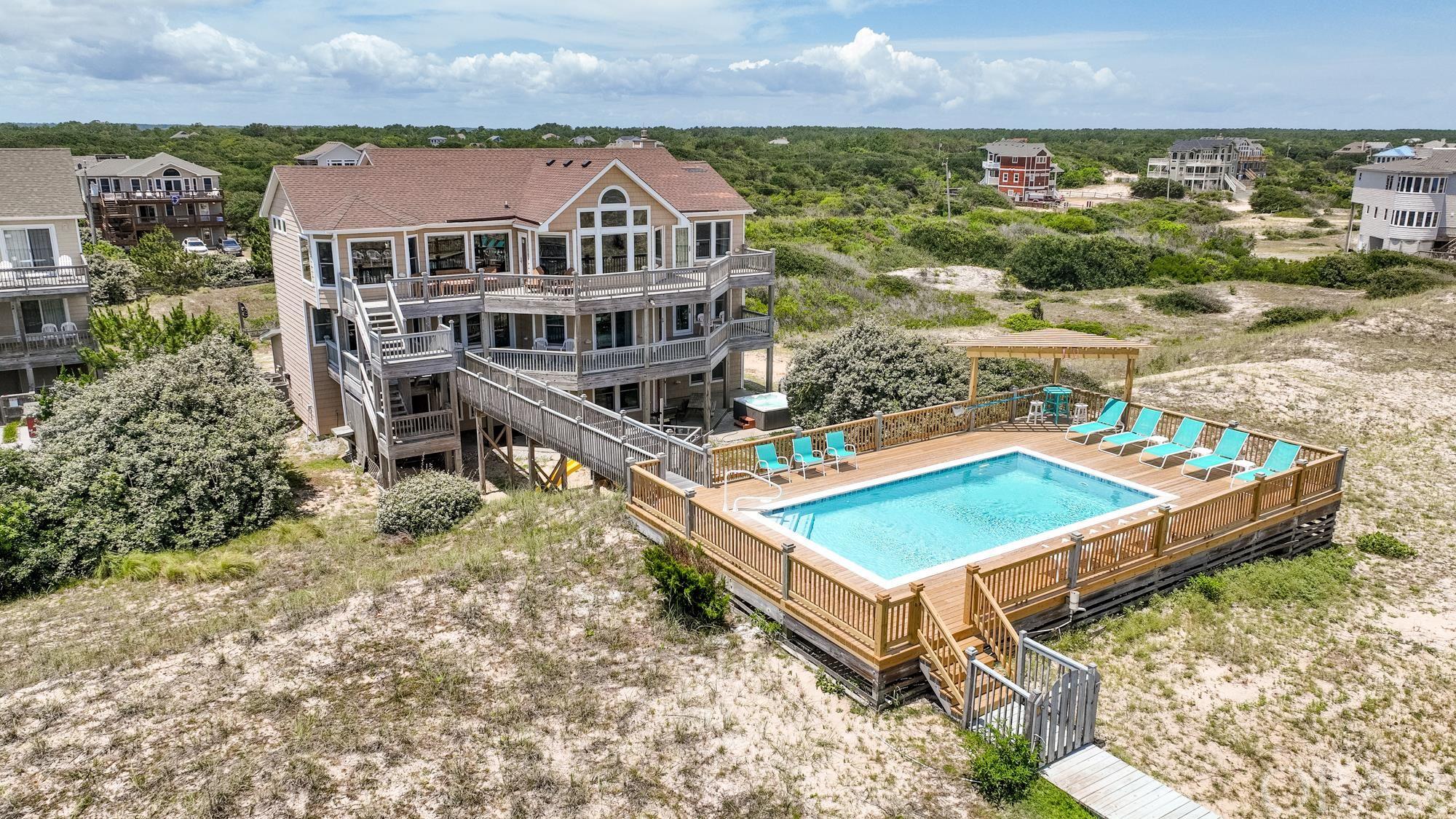 Accessible by 4x4 only, this custom built 8BR/8.5BA thoughtfully designed oceanfront retreat boasts spectacular ocean views and every conceivable amenity for the discerning buyer. On the top floor, the first of six master bedrooms w/fireplace, whirlpool tub, & deck access, an open concept living room w/entertainment center & gas fireplace, a half bath, dining room seating 20, a large tiled kitchen w/raised counter seating for 4, two dishwashers & a breakfast nook, a west side ships watch for sunset views, and eastside sun decks facing the sea. On the middle level, an entry foyer, four more master bedrooms (one handicap friendly), a bedroom, den/office, full hall bath, covered decks, a spacious elevated gated deck w/private pool, and a private walkway to the beach. On the ground level, another master bedroom, a bedroom, full hall bath, gameroom w/pool table, foosball & wet bar, ELEVATOR, laundry room, covered decks, hot tub, and pirate ship playground.  Currently this home is utilized as a vacation rental with considerable in-season owner use as well.  Full season rental projection on file for 2023 of $145,000 owner gross.  This home is a must see!