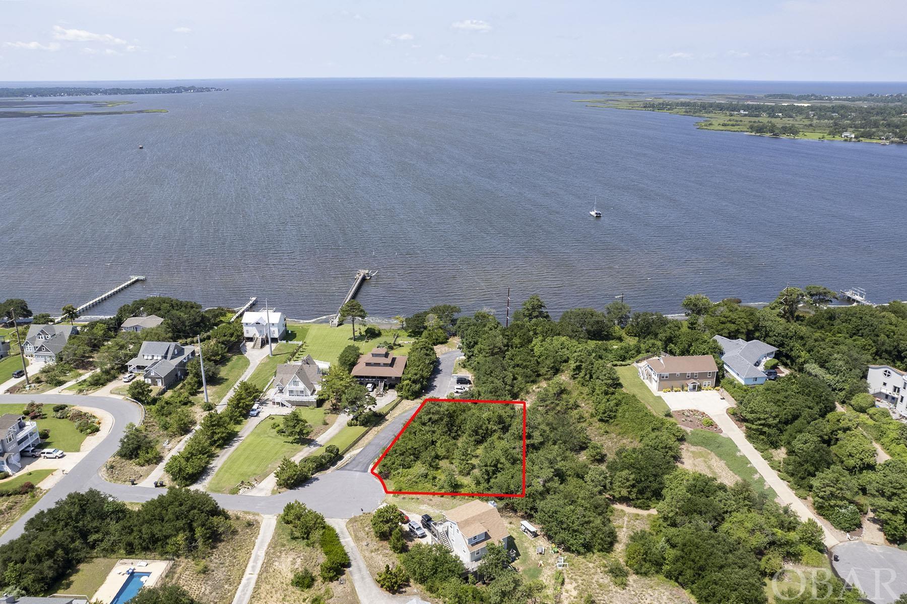 LOCATION! Build your dream home with amazing sunset and sound views in this incredible location in an elevated cul-de-sac off of Bay Drive! The Town of Kitty Hawk owns the land between this lot and the sound so no home will be built between your home and the water! This 17,500 sqft lot sits high and dry in the X flood zone. There is a town maintained public soundfront gazebo and water access literally steps down the street. It's the best of both worlds. You get to have amazing sound views, while having someone else maintain the sound access! There is a 5-bedroom septic site review on file. The Bay Drive area has a multi-use walking/biking path that runs along the sound for miles; it's a popular neighborhood for living, investing and sunset gazing. Close to the beach, shops and restaurants. This is an opportunity that doesn't come along very often. It is a gem of a location in a sought-after neighborhood.
