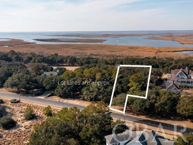 Build the home of your dreams on this beautiful soundfront build-site, tucked away in the gated Currituck Club Resort Community of Corolla. Backing up to the 16th Fairway of the world class 18-hole golf course designed by the legendary, Rees Jones, this parcel & a future home is likely to boast impressive views of the course, sound, and surrounding seaside vegetation. Enjoy the privacy & family-friendly atmosphere found in the community with gated entry and no through traffic, year-round security & fitness center, tennis courts, pickle ball, basketball, bocce ball, shuffleboard, and in-season trolley service, beach valet, and community pools throughout. Local shops, restaurants, and attractions are just a short walk or bike ride away.
