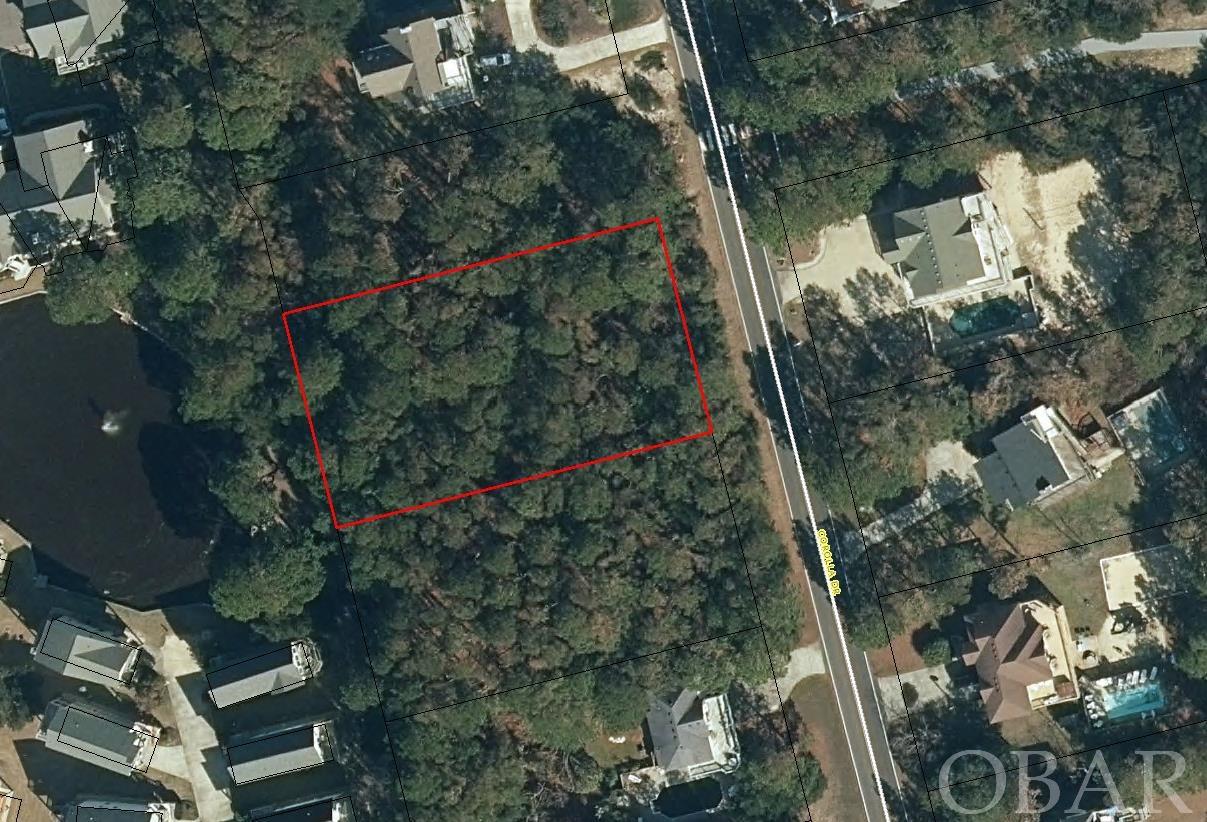 Build the home of your dreams! This large 22,000 sq ft lot offers the perfect setting whether it be your primary home. 2nd home or vacation rental/investment home. This beautiful homesite is currently wooded with medium size pines. Once trees are thinned out for construction, this location should offer a nice view of the tranquil pond to the west located in the Mirage section of Corolla Light. This is a corner lot adjacent to 60' Sturgeon St. unimproved right of way which will provide additional privacy to the north, as  well as direct beach access. The lot is located in a ‘X’ flood zone so flood insurance should not required once you construct your home. The adjacent lot to the south, 1044 Corolla Drive, is also available to purchase (see MLS #119980). The Whalehead Club subdivision is known for its large lots and expansive beautiful beaches. This subdivision is centrally located for quick access to shops, restaurants, tourist attractions and recreational activities.