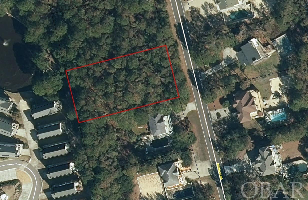 Build the home of your dreams! This large 20,000 sq ft lot offers the perfect setting whether it be your primary home, 2nd home or vacation rental/investment home. This beautiful homesite is currently wooded with medium size pines. Once trees are thinned out for construction. it should offer a nice view of the tranquil pond to the northwest located in the Mirage section of Corolla Light. It is 110' south of the 60' Sturgeon St. unimproved right of way which will provide direct beach access. The lot is located in a ‘X’ flood zone so flood insurance should not required once you construct your home. The Whalehead Club subdivision is known for its large lots and expansive beautiful beaches. This subdivision is centrally located for quick access to shops, restaurants, tourist attractions and recreational activities.
