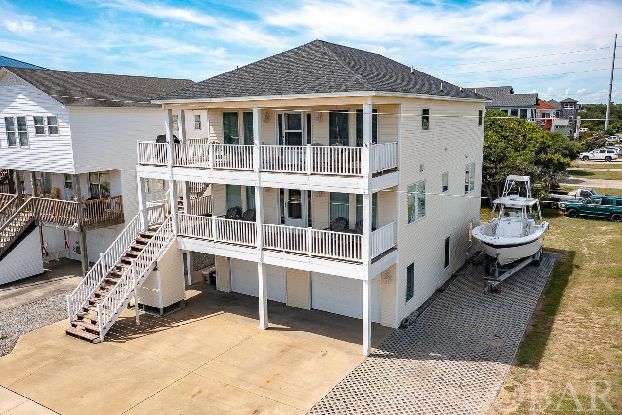 Enjoy beach living in this centrally located home with elevator, 2 car garage and oceanviews!Located on a corner lot, and a 5 minute walk to the beach-be sure to schedule your tour!This reverse floor plan home offers plenty of space for family and friends-or great rental potential.The top level consists of the updated kitchen with granite counter tops, large center island to gather, viking cooktop and brand new stainless oven.Tile floors throughout. Large living area leads to covered deck offering a great place to relax and enjoy the oceanviews.The primary bedroom is on this level, and large bathroom with jetted tub and seperate shower. Take the elevator, indoor or outdoor stairway down to the 2nd level which consists of 2 bedrooms with shared full bath,ample living space including a pool table,as well as access to 2nd level covered deck  Ground level offers additional living space with full kitchen, as well as a two car garage. Outdoor shower is located just outside. All floors have access to ground level from outside or elevator.Ample parking too! Close to public beach accesses,Stop&Shop,and many restaurants and shops.Located in an X Flood zone.New roof 2021,HVAC 2018 and 2015,Hot Water Heater 2019.Rental projection in docs.