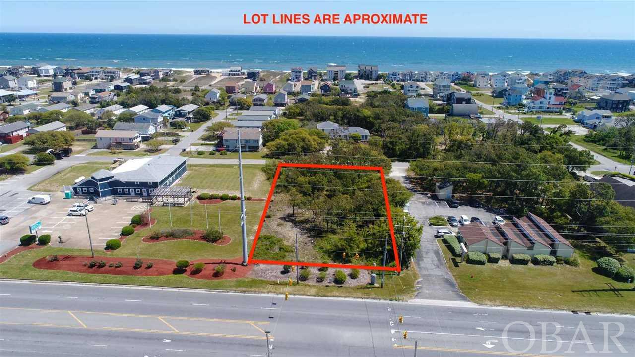 Fantastic Commercial Site with 100 feet of HWY 158 Road Frontage.  Prime location in Nags Head!   It is possible that this lot can have full stop light access by modification of the current light.  Approval letter on file from NC DOT, which would put a business at a central business location with excellent visibility and access.  Also, the lot is bounded on the East side by S Wrightsville Ave.,  giving dual access to the property.  A Fantastic Opportunity!!