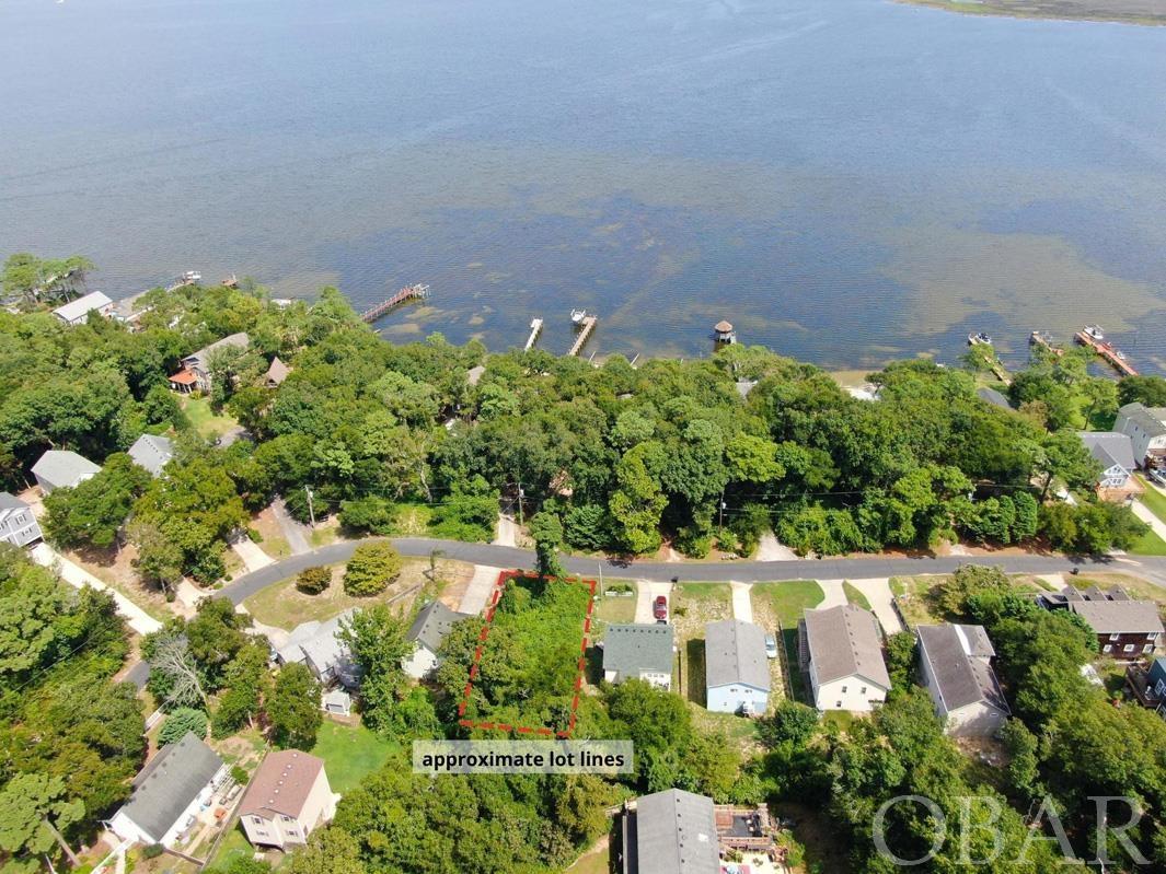Wonderful opportunity to build your dream home on a quiet, residential street in the gated deep water boating community of Colington Harbour. This lot is just a short walk down the street (.2 miles) to the community's soundside Kitty Hawk Bay access - the perfect place to enjoy a sunset on the water. Less than half a mile from the numerous amenities Colington Harbour residents enjoy including a clubhouse, marina with slips and boat ramp, an Olympic size saltwater swimming pool, soundfront park, and playground with soundside beach access and tennis courts. Located in an X-flood zone, no flood insurance is required.