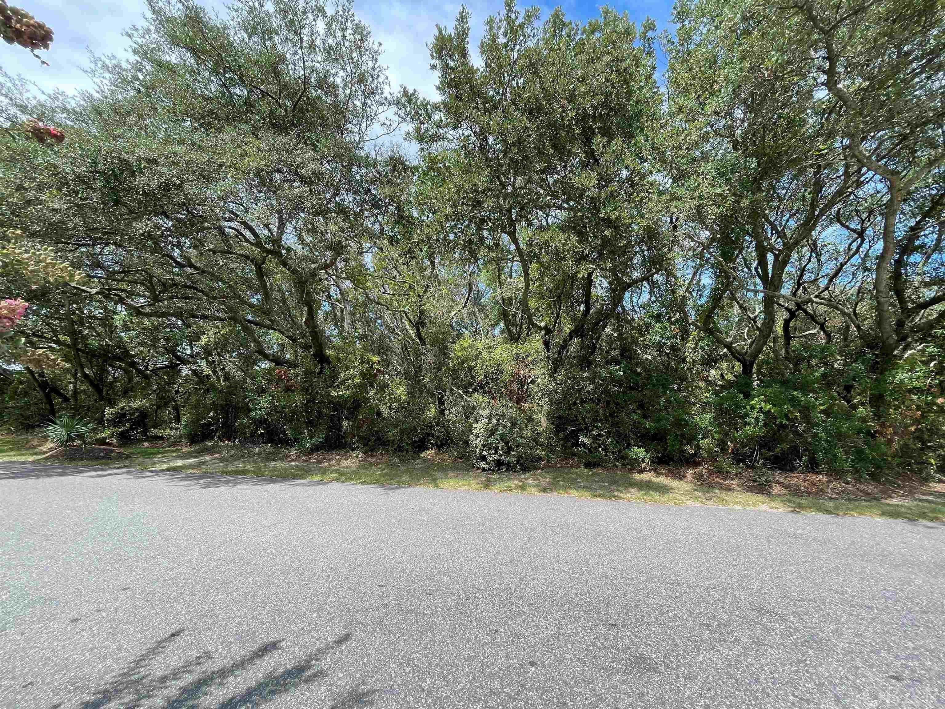 Gorgeous live oaks abound on this beautiful oceanside lot located in Caffey's Inlet Hamlet.  This is a corner lot with more than 16,000 sq. ft and located directly across the street from the Currituck Sound.  A home built on this property would have an unobstructed view of the sound as it overlooks the private soundside access and park area for the subdivision.  This is an ideal spot to enjoy the famous sunsets or maybe take out your canoe or kayak.  Caffey's Inlet Hamlet has a quaint neighborhood feel with tree lined streets and private ocean and sound access.  Close enough to the village of Duck yet away from it all!  The oceanside bike path allows easy access to all the amenities that Duck has to offer!